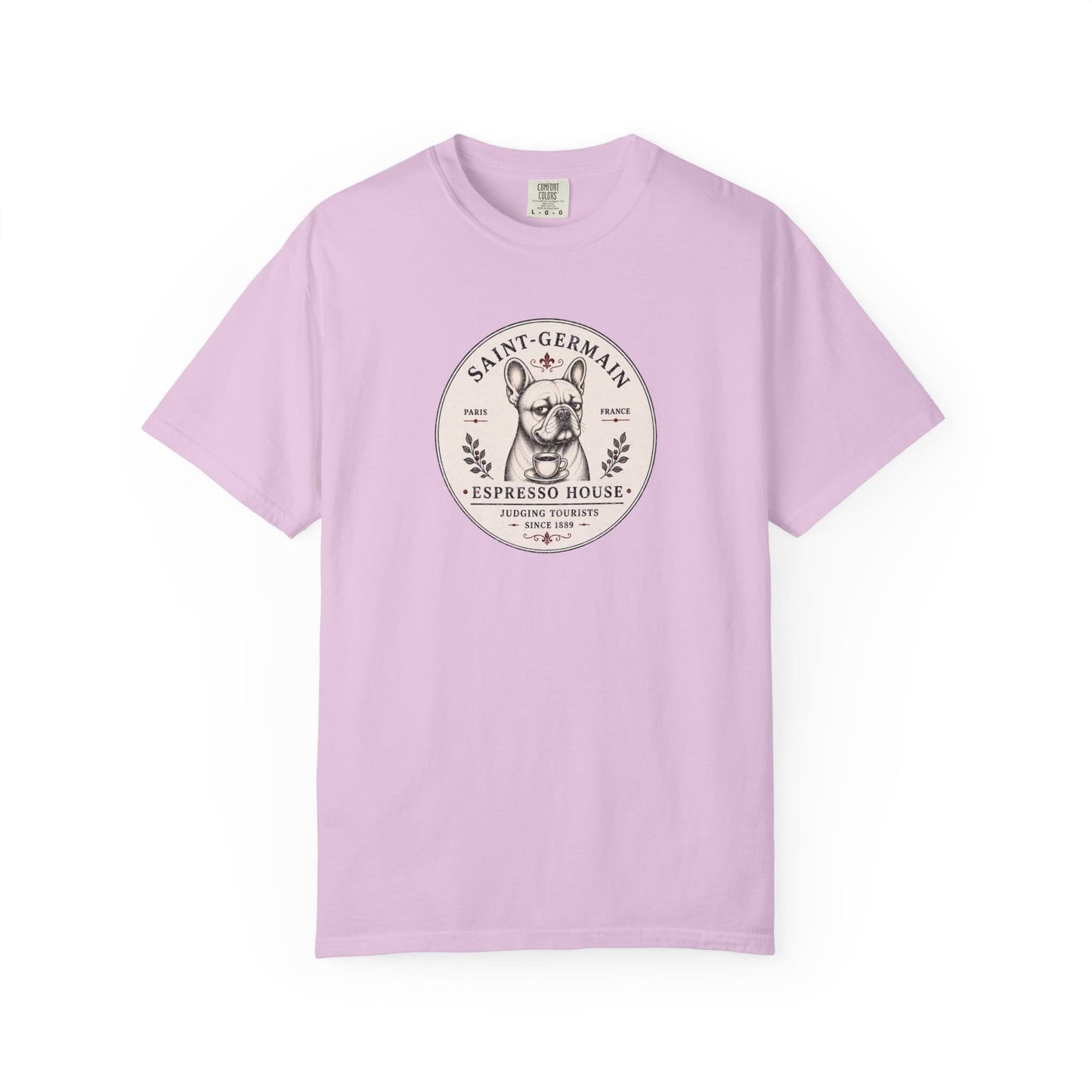 Saint-Germain Espresso House French Bulldog graphic t-shirt featuring the slogan "Judging Tourists Since 1889" and vintage Paris café artwork in Pastel Pink color.