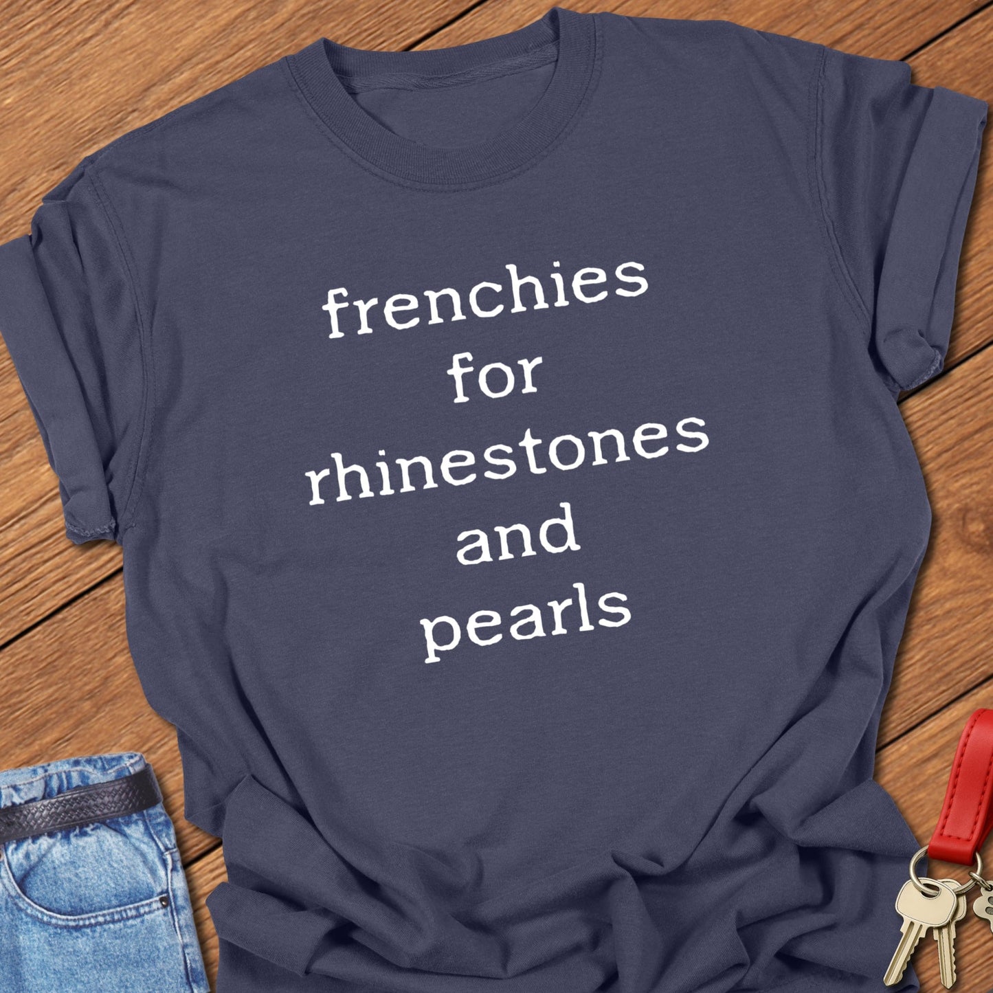French bulldog typography quote design reading “frenchies for rhinestones and pearls” printed on navy Comfort Colors t shirt