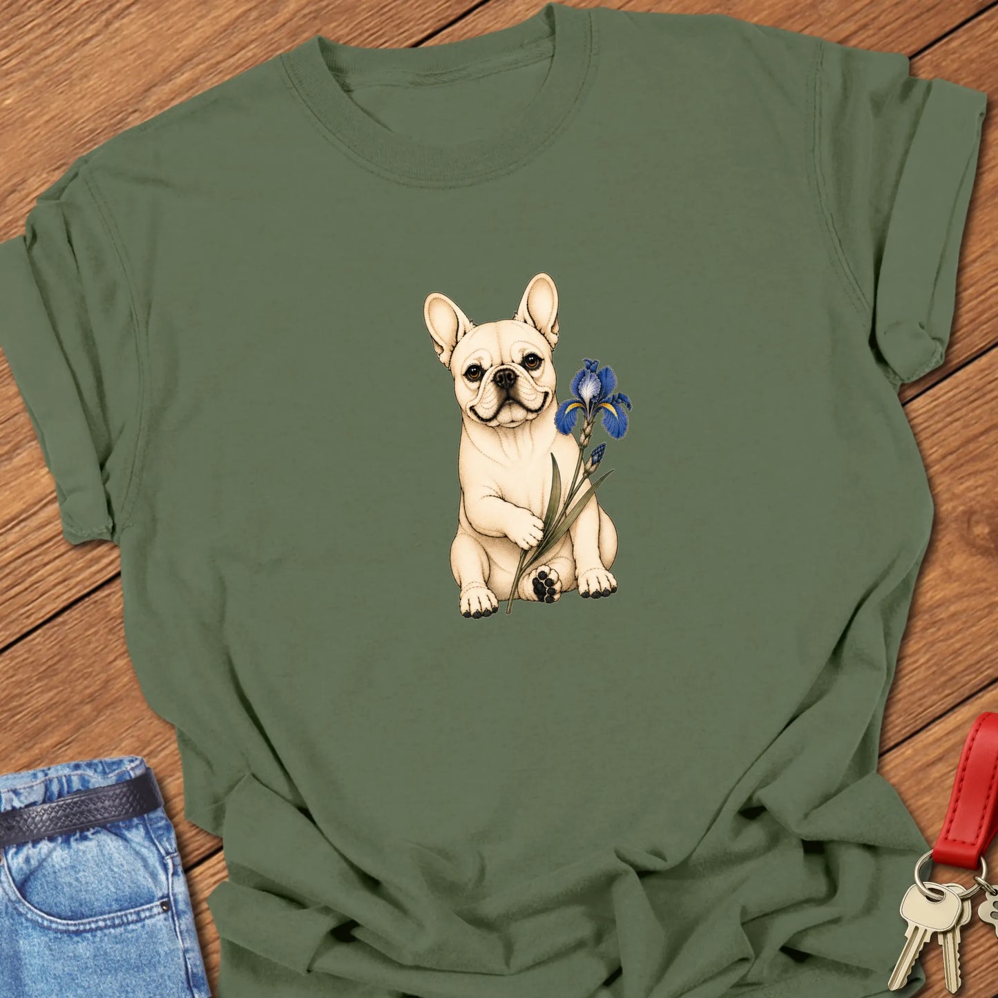 Frenchie Blue Iris Art cream French Bulldog holding blue iris flower printed on Comfort Colors® t-shirt in Moss Color
