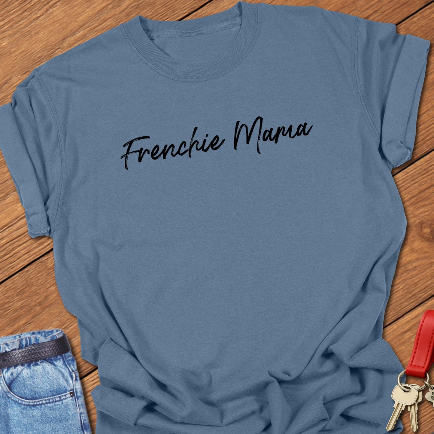French bulldog “Frenchie Mama” handwritten script text design printed on blue jean Comfort Colors t shirt.