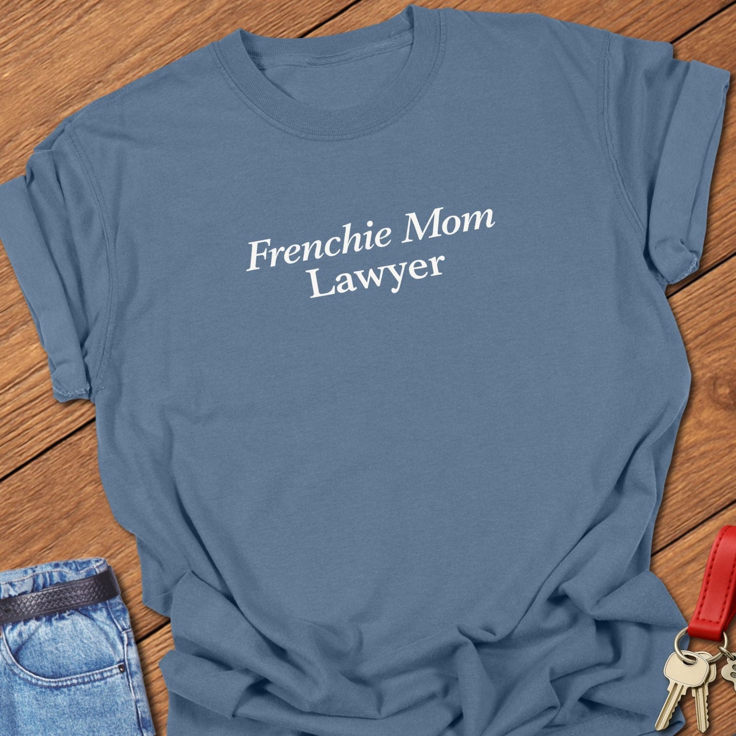 Minimalist serif text design reading “Frenchie Mom Lawyer” on garment-dyed Comfort Colors t shirt in blue jean.