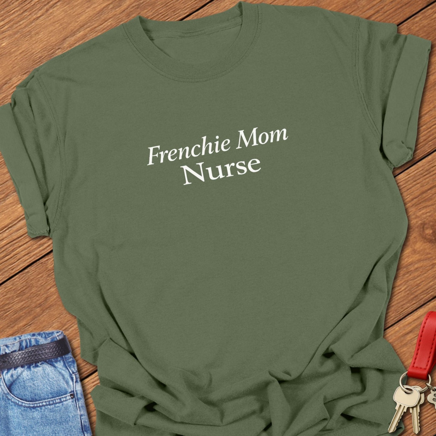 Minimalist serif text design reading “Frenchie Mom Nurse” on garment-dyed Comfort Colors t shirt in moss.