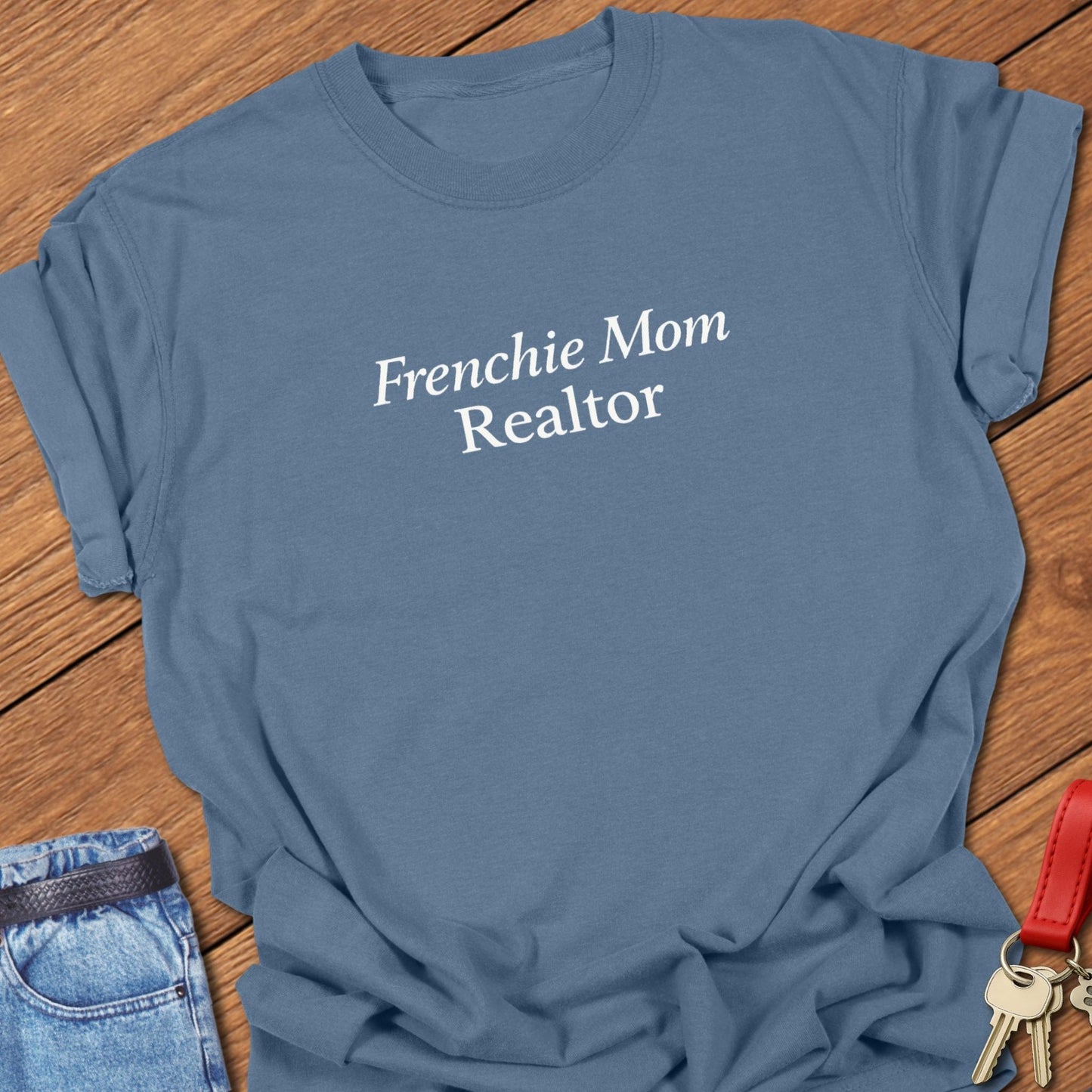 Minimalist serif text design reading “Frenchie Mom Realtor” on garment-dyed Comfort Colors t shirt in blue jean.