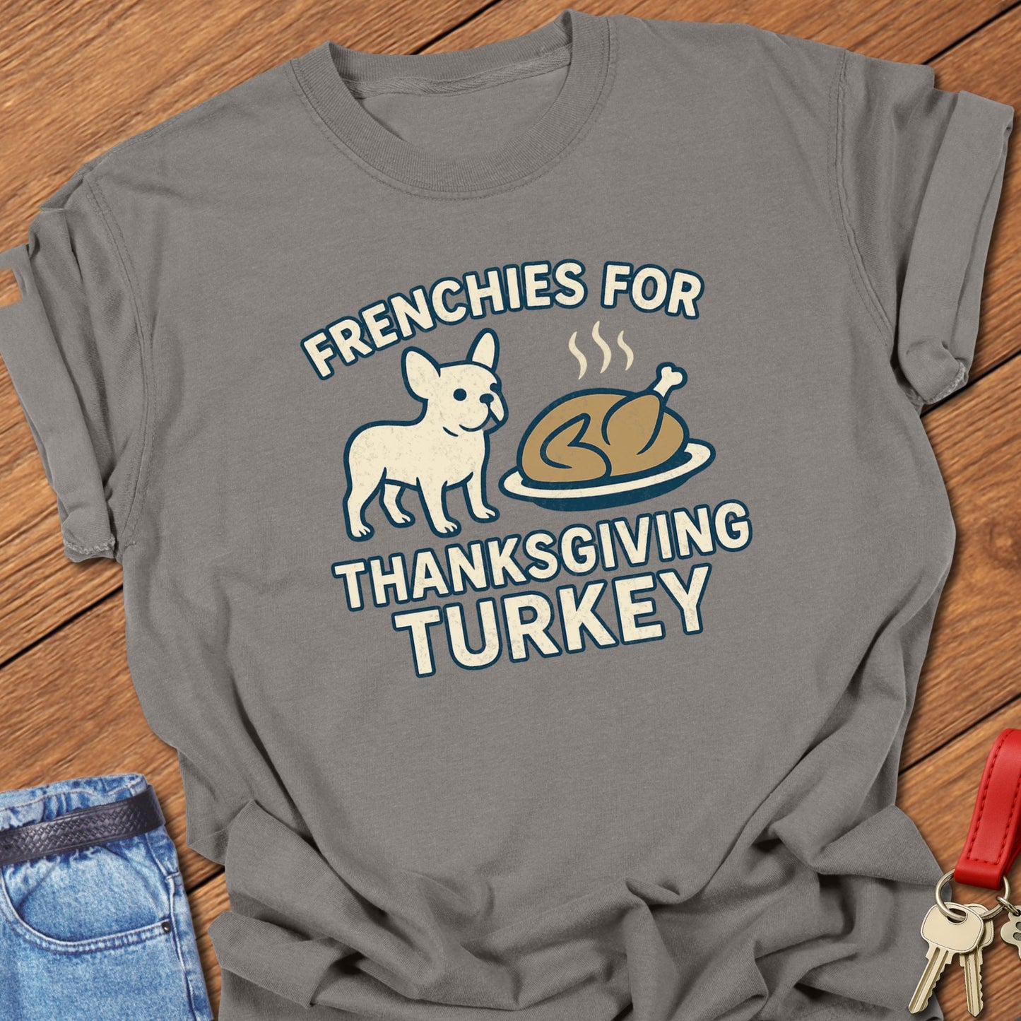 French bulldog Thanksgiving illustration with cartoon Frenchie and roasted turkey graphic printed on grey Comfort Colors t shirt