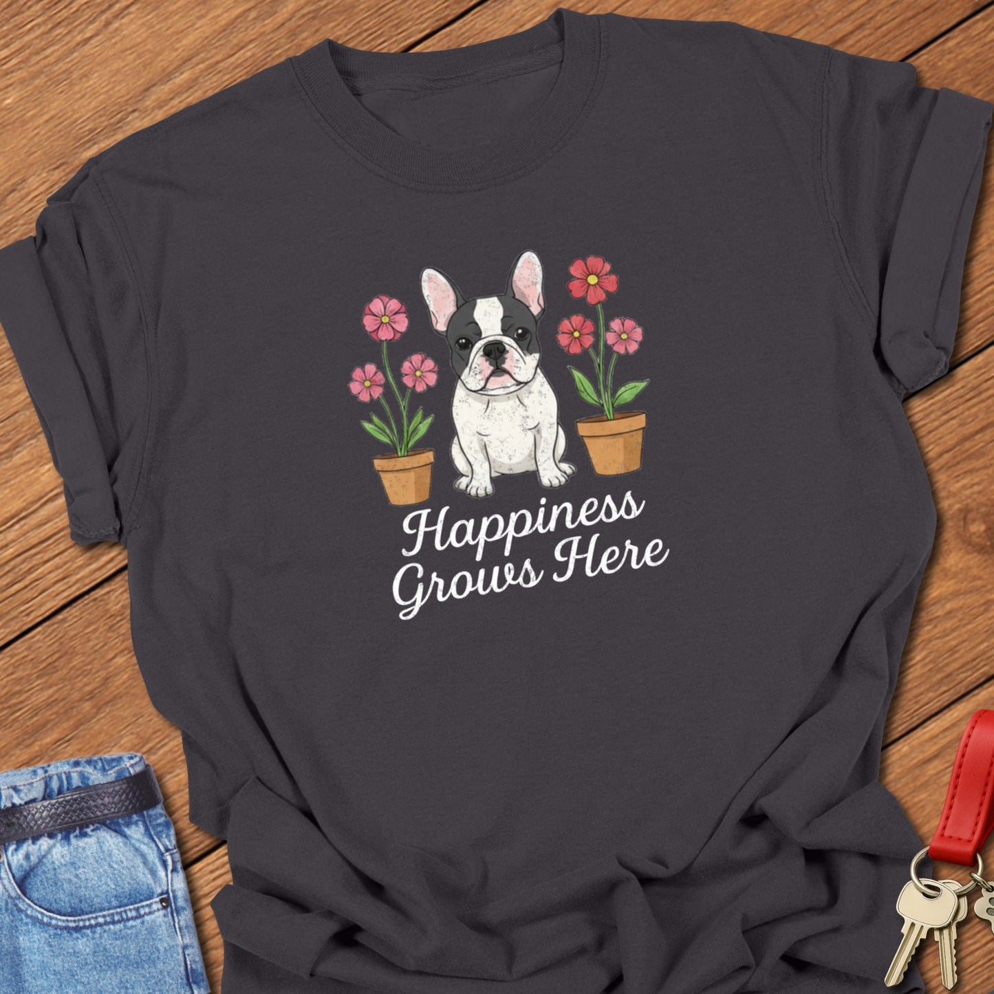 French bulldog illustrated puppy with flowers and “Happiness Grows Here” text printed on graphite Comfort Colors t shirt