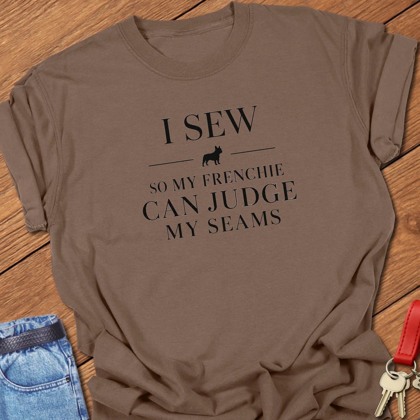 I Sew So My Frenchie Can Judge My Seams text design along with a French Bulldog silhouette on a Comfort Colors 1717 t shirt in Espresso color.