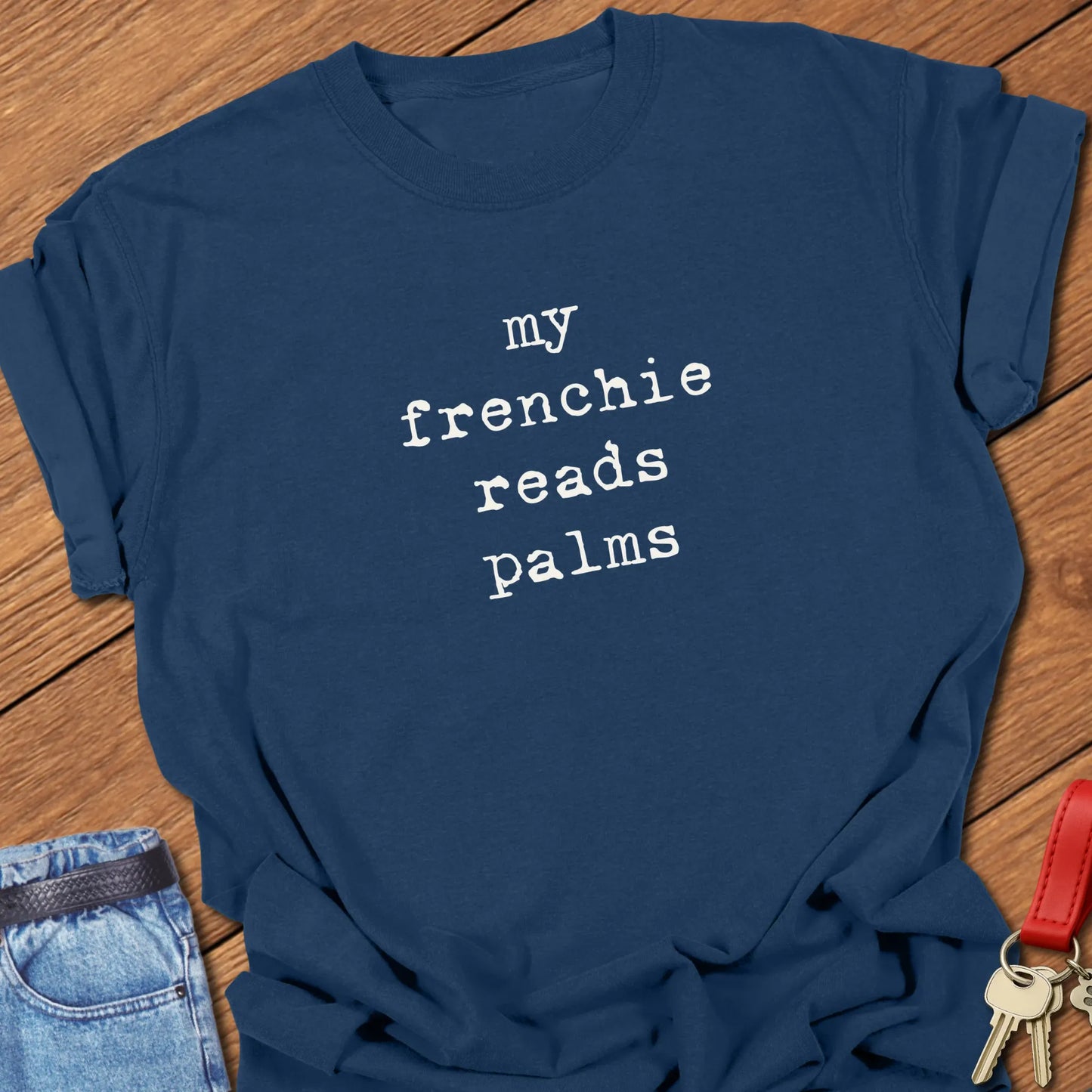 Typewriter-style typography featuring the slogan "My Frenchie Reads Palms" printed on a Comfort Colors® garment-dyed t-shirt in True Navy color.