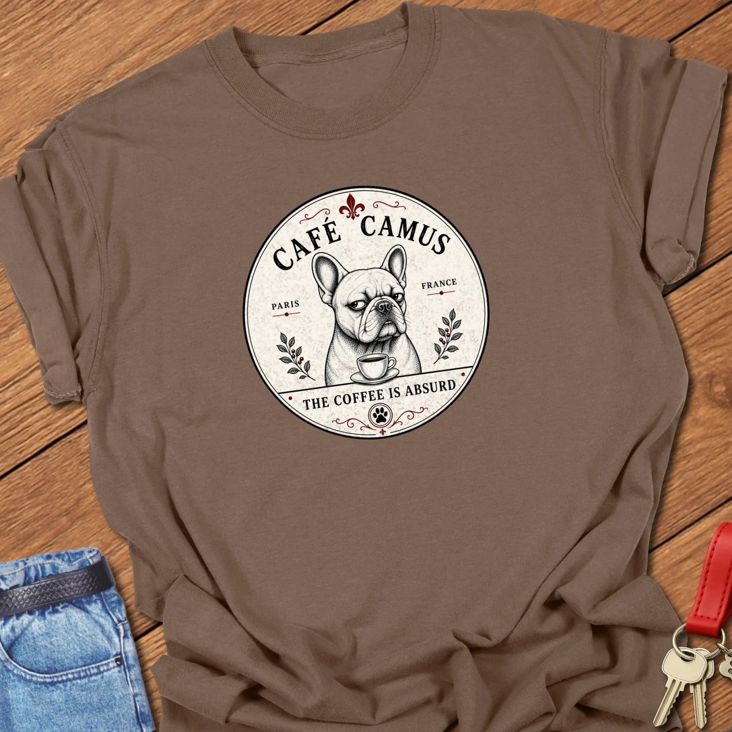 Absurd Coffee French Bulldog graphic t-shirt featuring Café Camus artwork and "The Coffee Is Absurd" slogan in Espresso color.