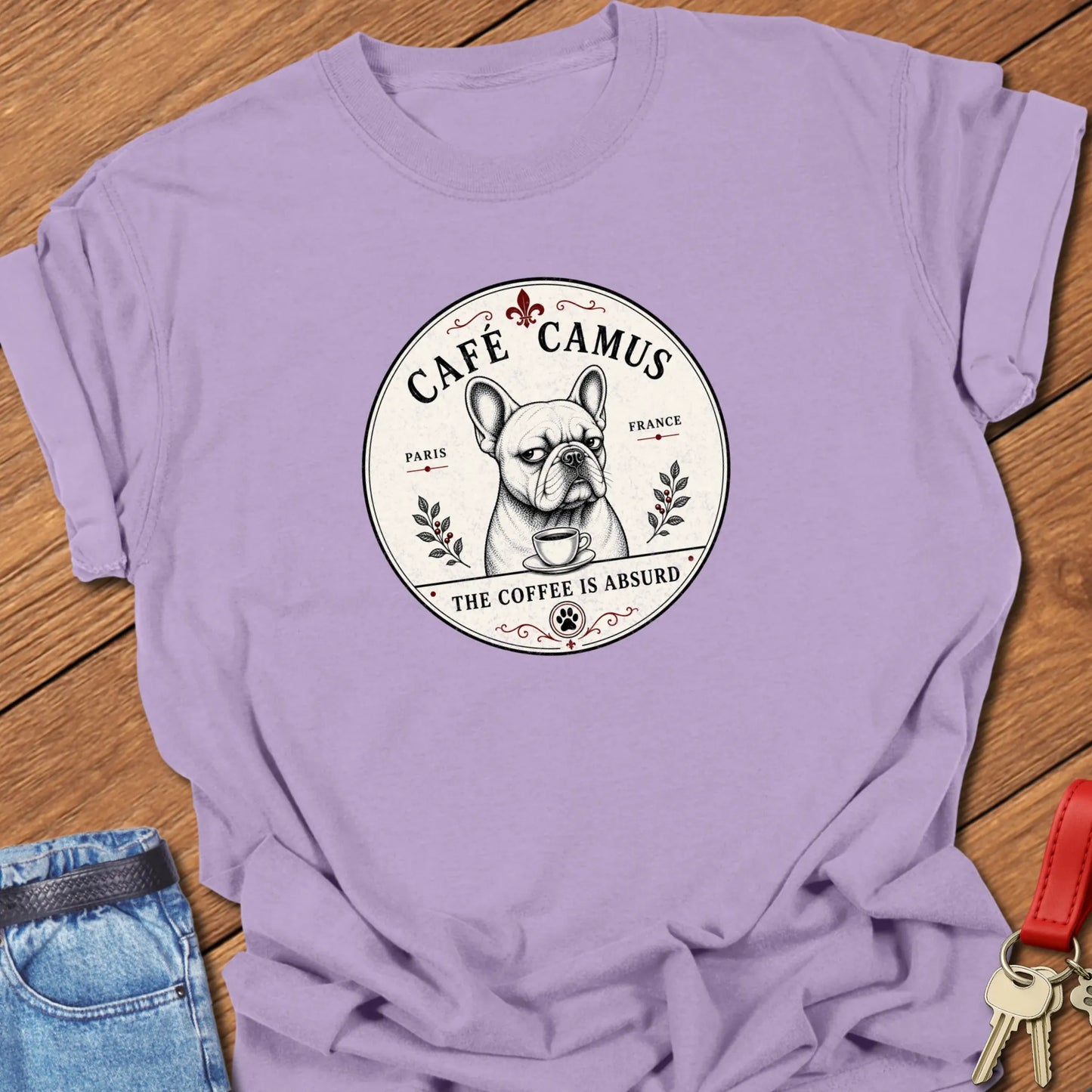 Absurd Coffee French Bulldog graphic t-shirt featuring Café Camus artwork and "The Coffee Is Absurd" slogan in Orchid color.