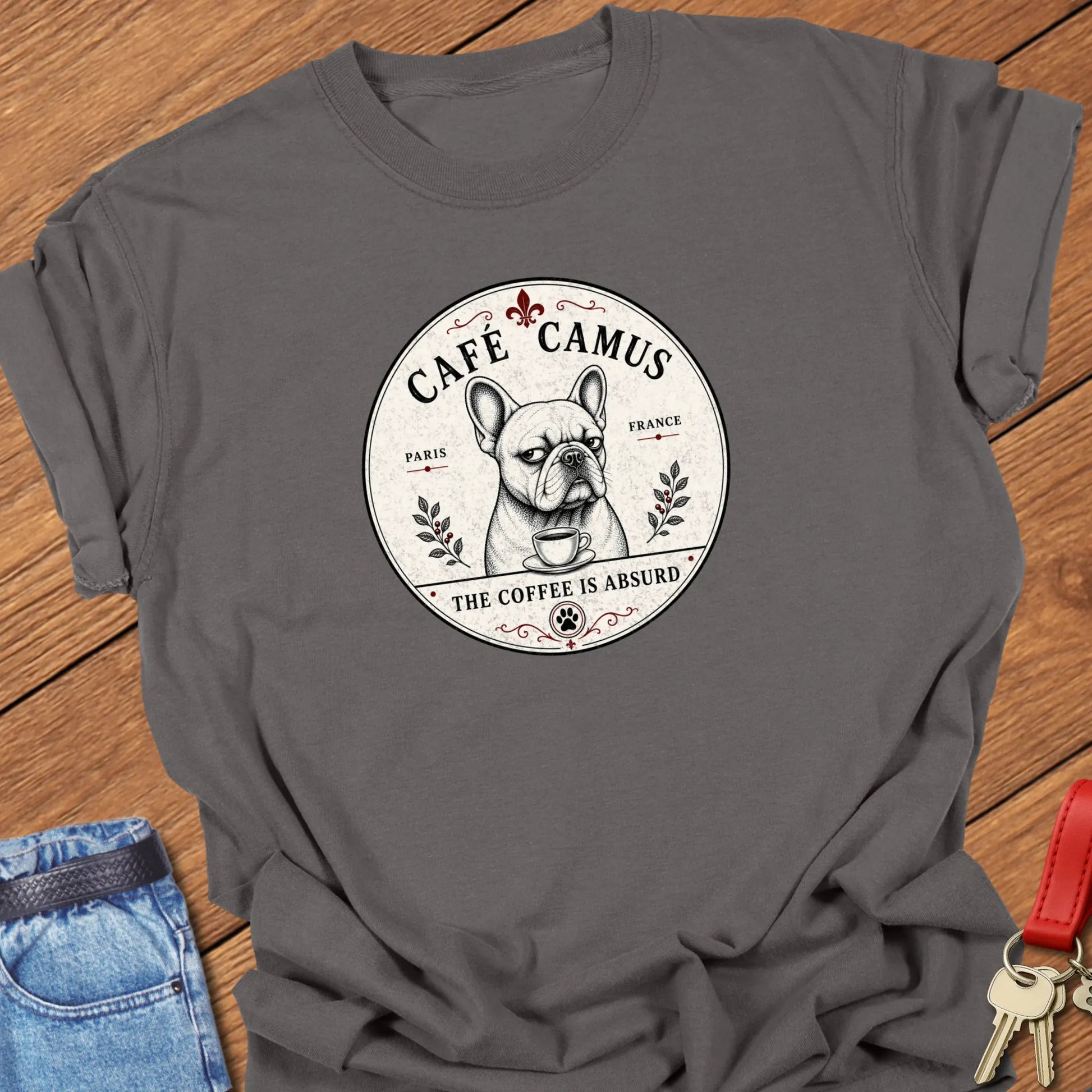 Absurd Coffee French Bulldog graphic t-shirt featuring Café Camus artwork and "The Coffee Is Absurd" slogan in Pepper color.