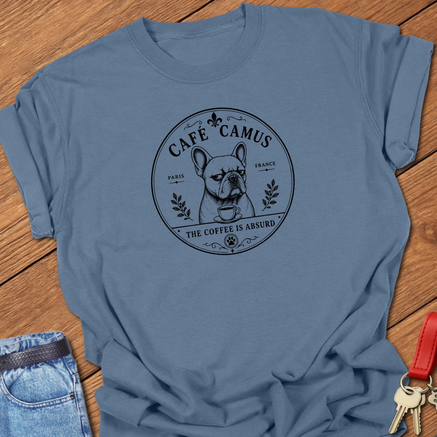 Café Camus French Bulldog literary coffee t-shirt featuring the slogan "The Coffee Is Absurd" in Blue Jean color with vintage Paris café-inspired artwork.