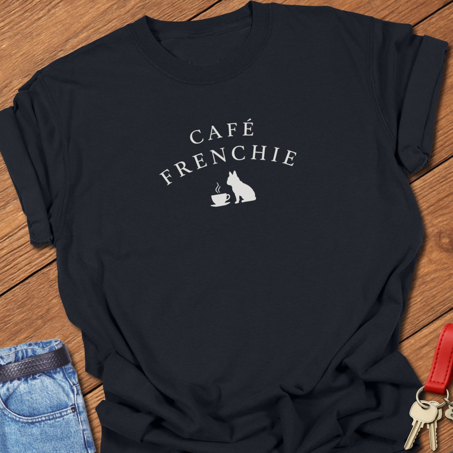 Café Frenchie French Bulldog graphic t-shirt in Comfort Colors Black featuring a coffee cup and Frenchie silhouette design in soft ivory ink.