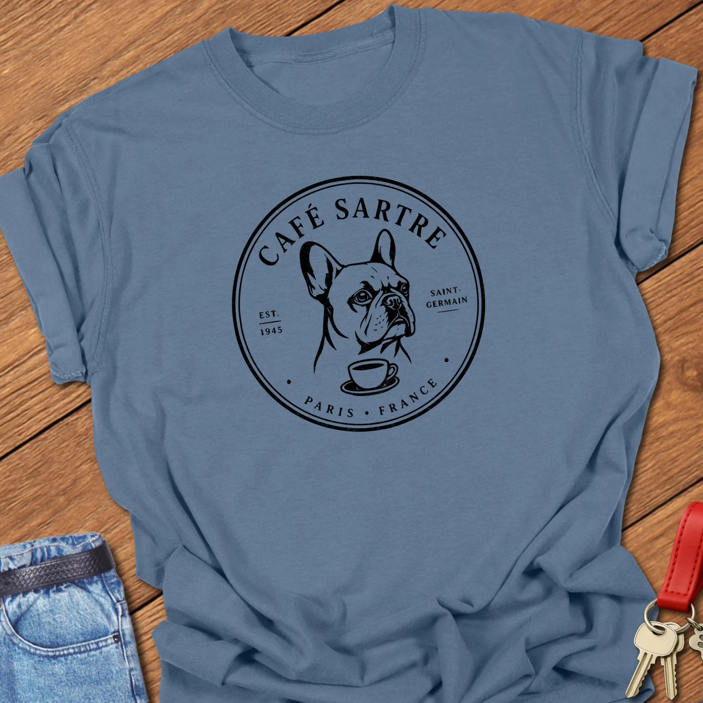 Café Sartre Paris French Bulldog graphic t-shirt featuring minimalist Saint-Germain café artwork and literary-inspired design in Blue Jean color.