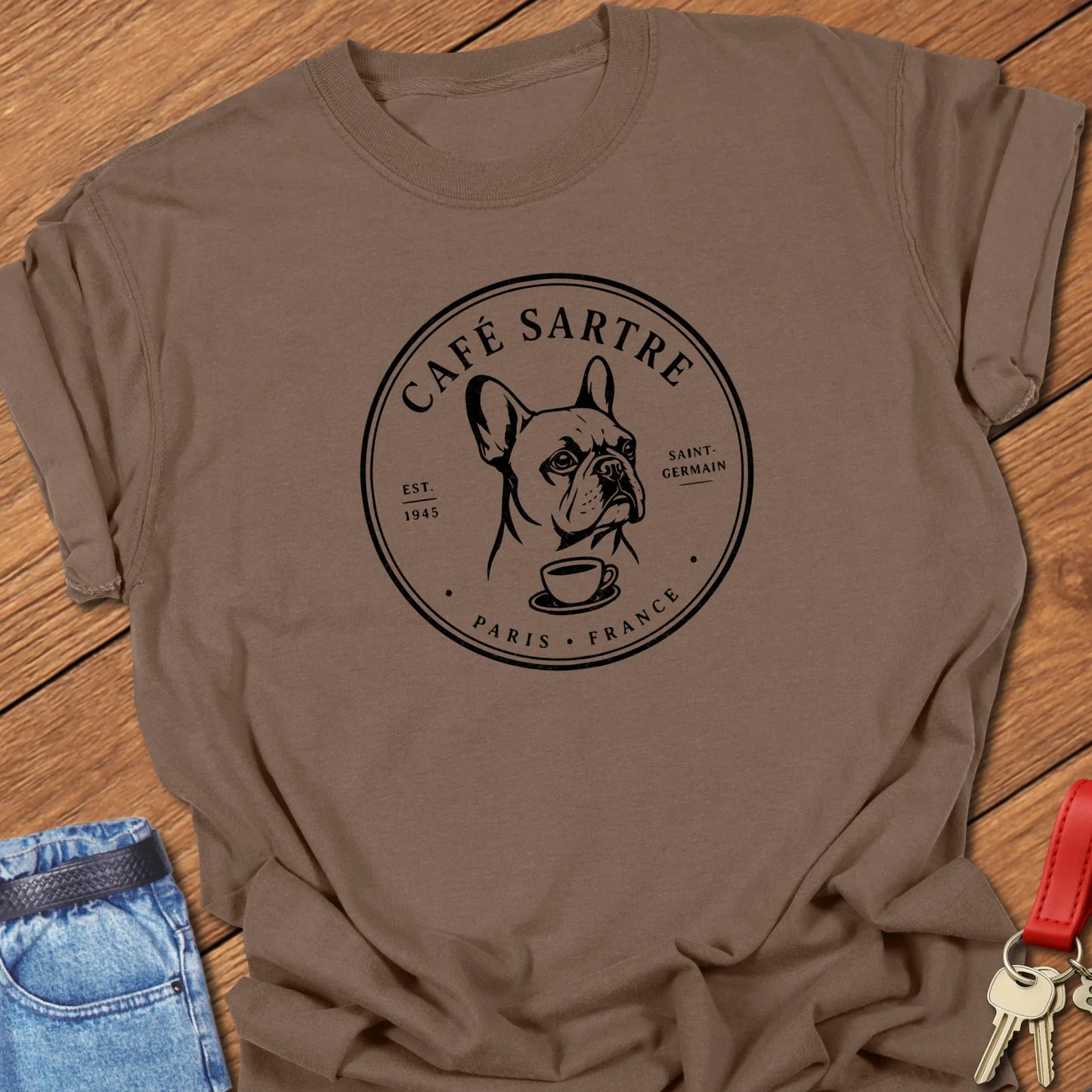 Café Sartre Paris French Bulldog graphic t-shirt featuring minimalist Saint-Germain café artwork and literary-inspired design in Espresso color.