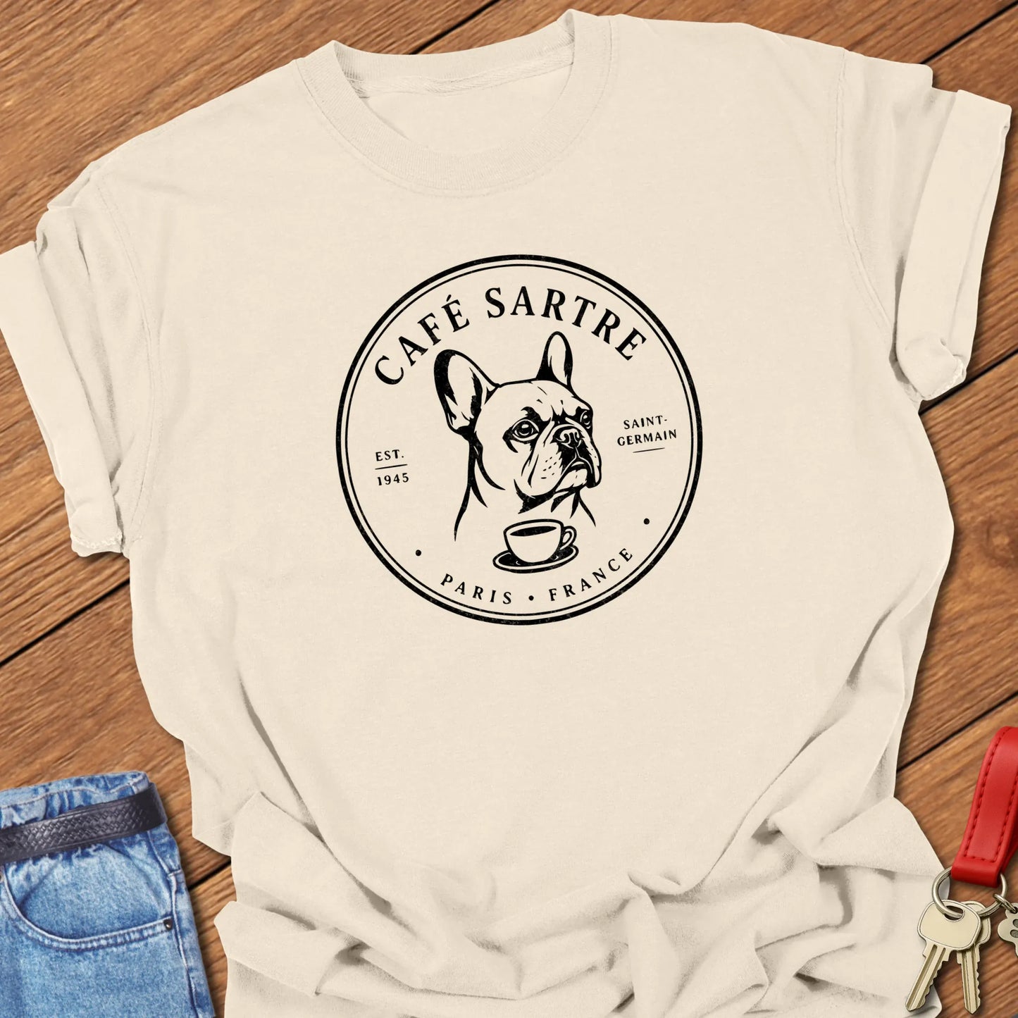 Café Sartre Paris French Bulldog graphic t-shirt featuring minimalist Saint-Germain café artwork and literary-inspired design in Ivory color.