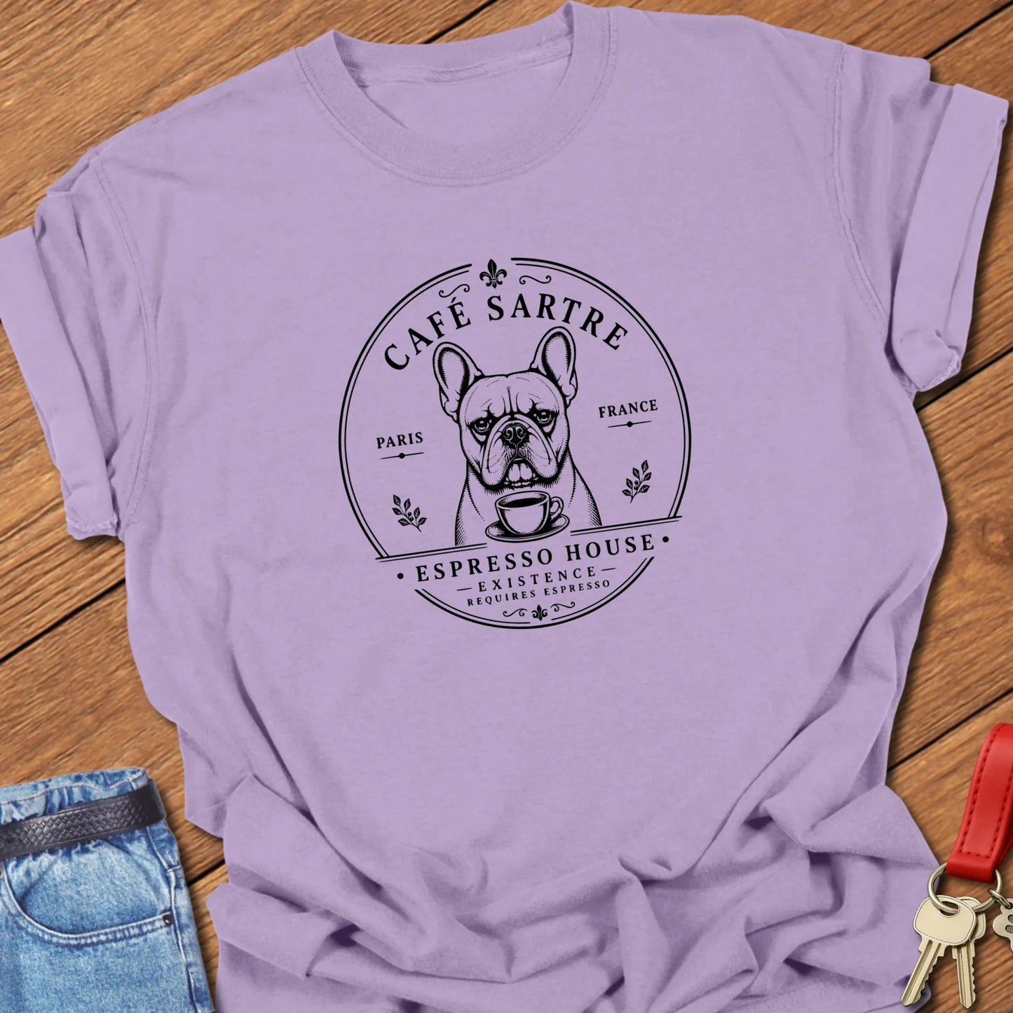 Café Sartre French Bulldog graphic t-shirt featuring "Existence Requires Espresso" slogan with vintage Paris café artwork in Orchid color.
