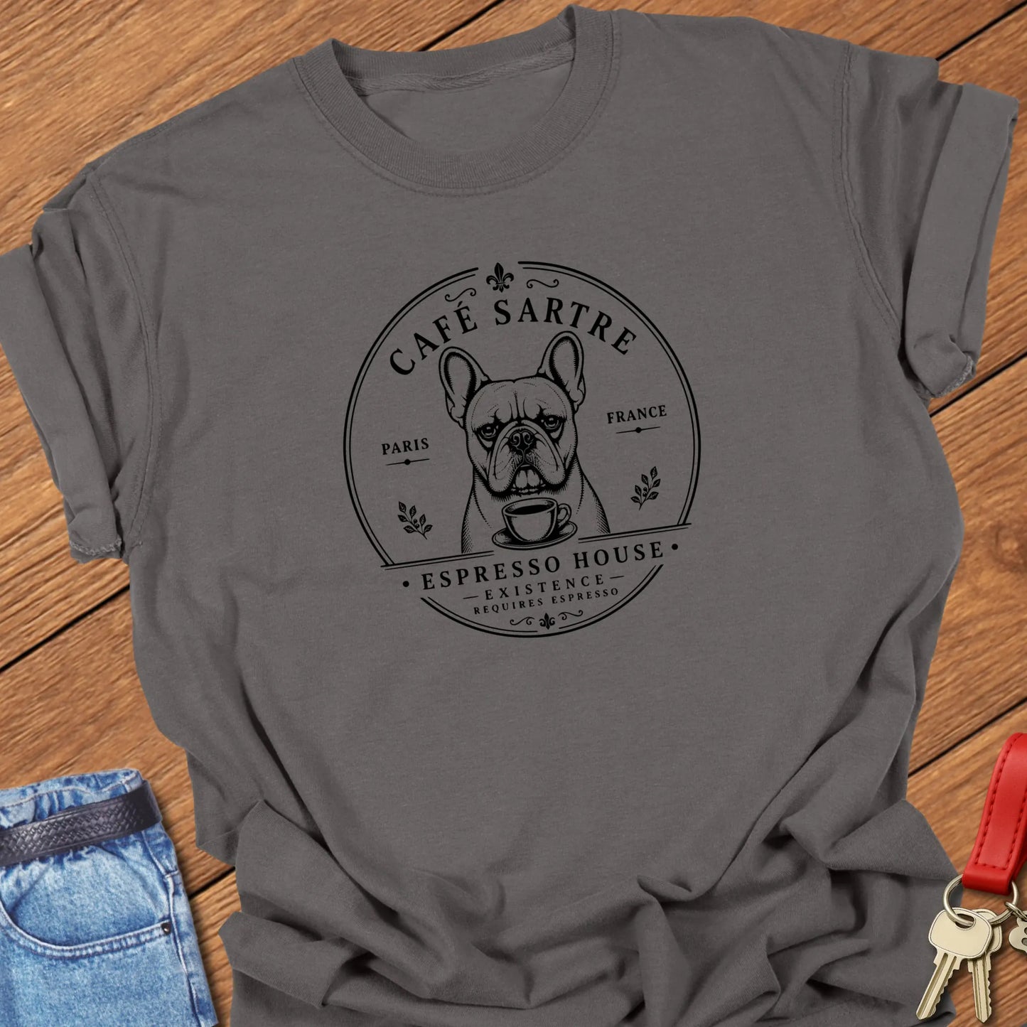 Café Sartre French Bulldog graphic t-shirt featuring "Existence Requires Espresso" slogan with vintage Paris café artwork in Pepper color.