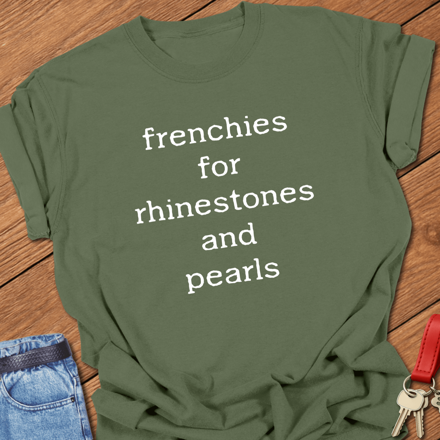 French bulldog typography quote design reading “frenchies for rhinestones and pearls” printed on moss Comfort Colors t shirt