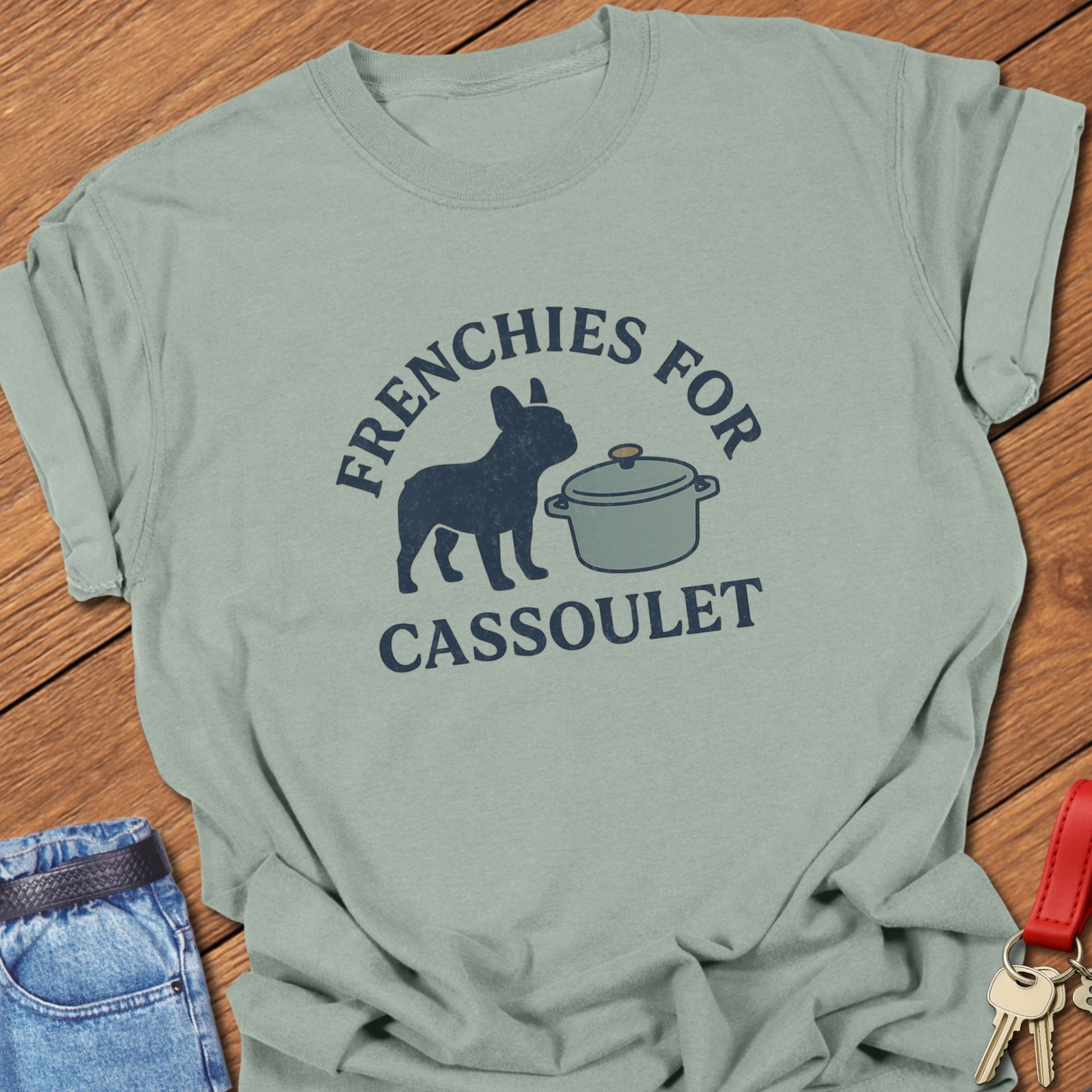 French bulldog humorous French food illustration with cassoulet pot graphic and bold typography printed on bay Comfort Colors t shirt