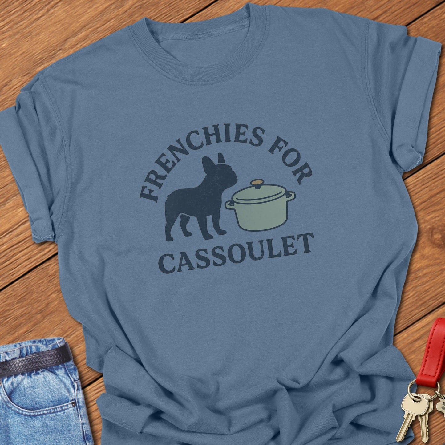 French bulldog humorous French food illustration with cassoulet pot graphic and bold typography printed on blue jean Comfort Colors t shirt