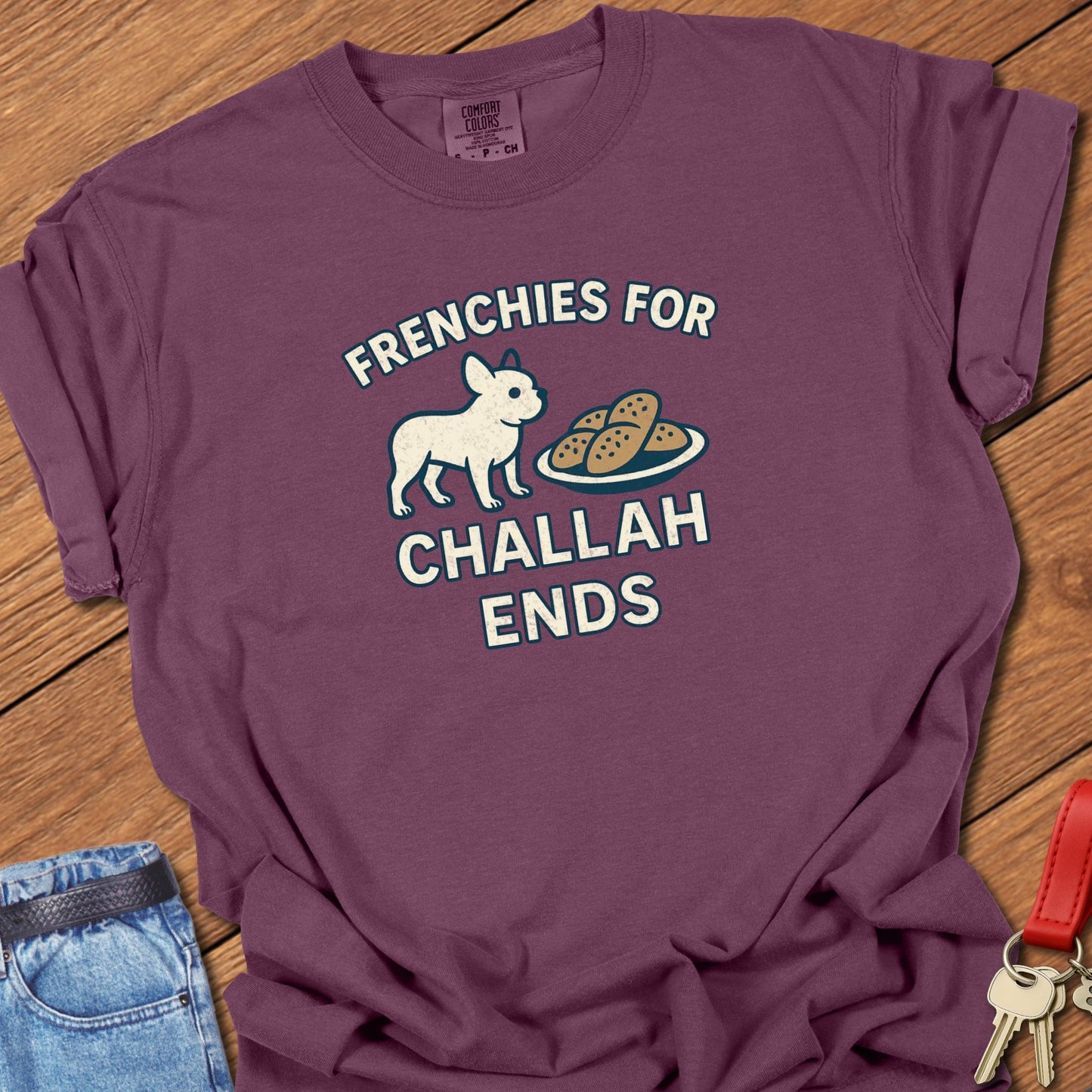 French bulldog humorous food illustration with challah bread graphic and playful slogan printed on berry Comfort Colors t shirt