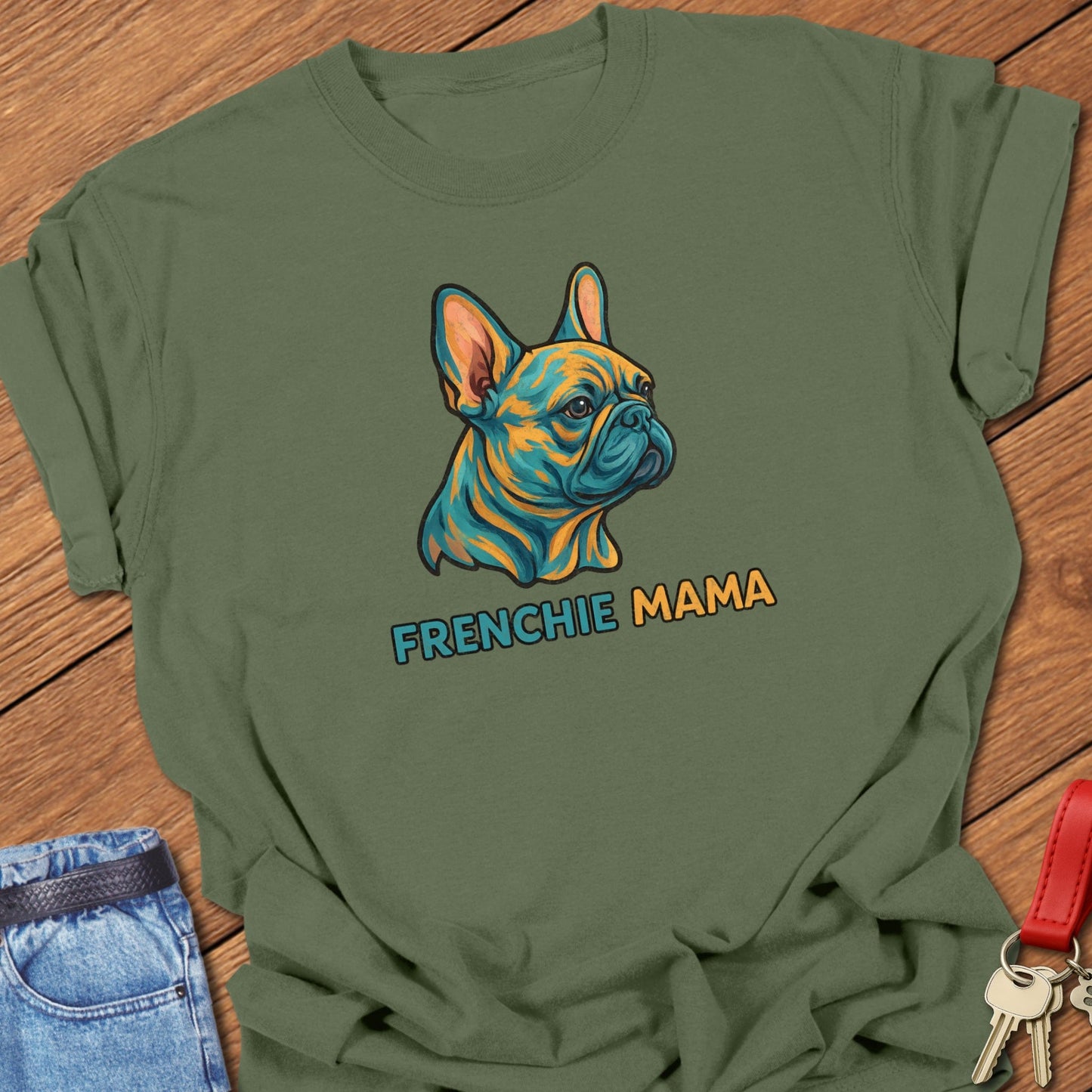 French bulldog colorful illustrated head with bold “Frenchie Mama” text printed on moss Comfort Colors t shirt