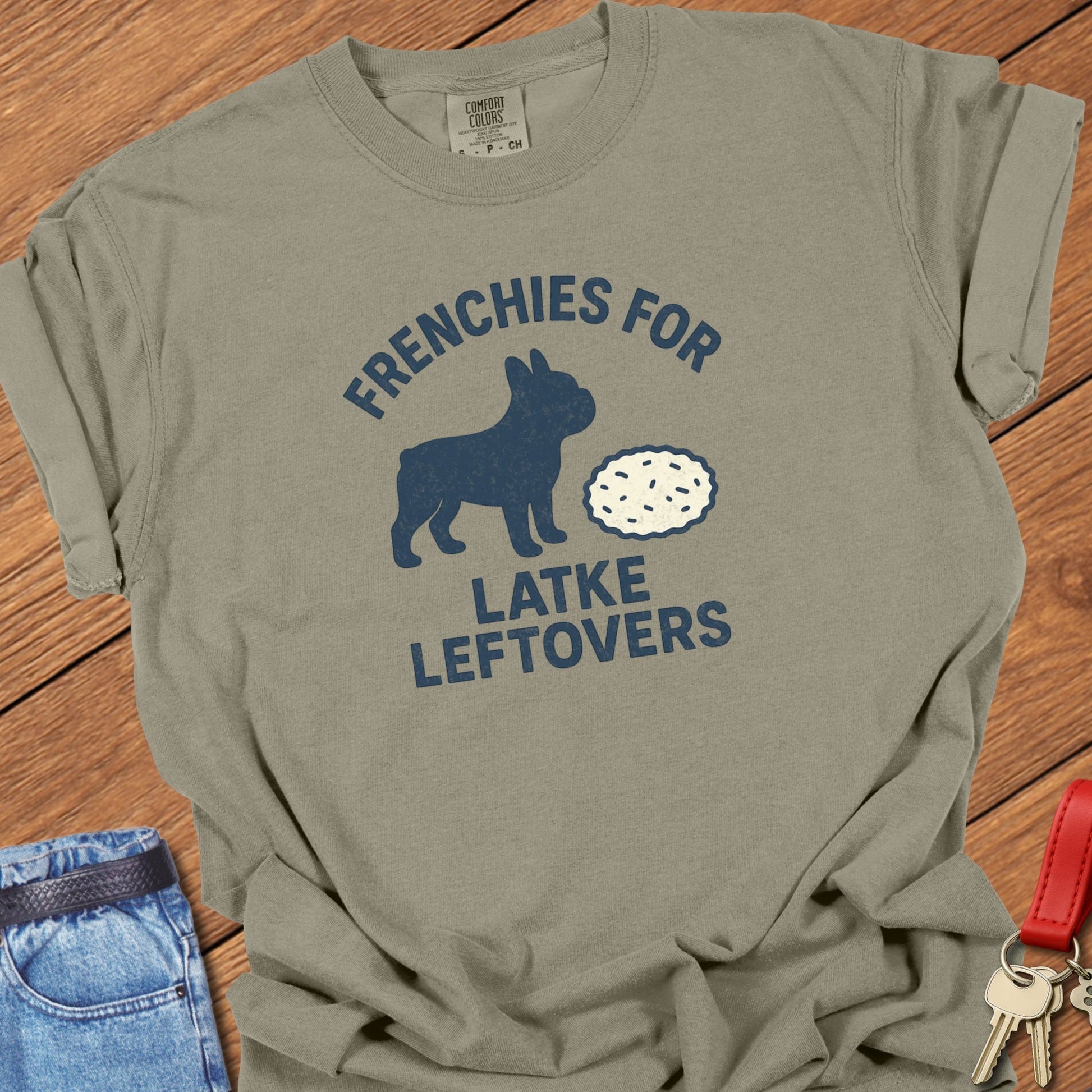 French bulldog humorous food illustration with latke graphic and playful slogan printed on khaki Comfort Colors t shirt