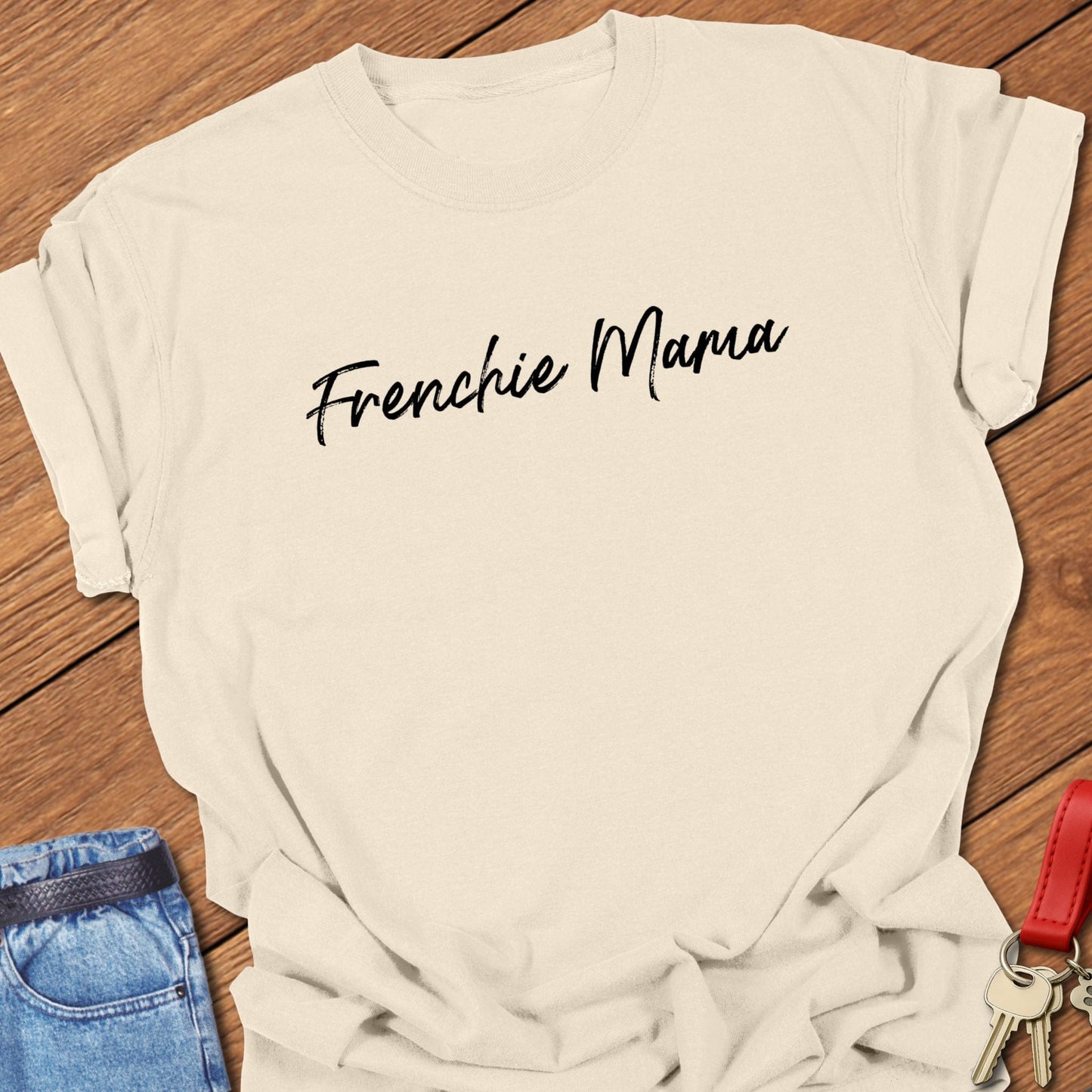French bulldog “Frenchie Mama” handwritten script text design printed on ivory Comfort Colors t shirt.