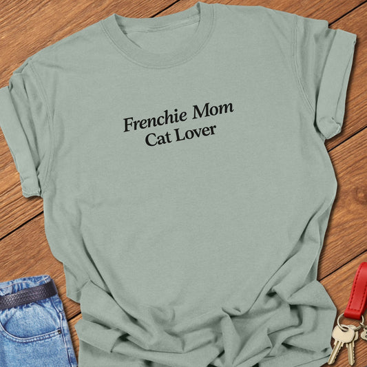 Minimalist serif text design reading “Frenchie Mom Cat Lover” on garment-dyed Comfort Colors t shirt in bay.