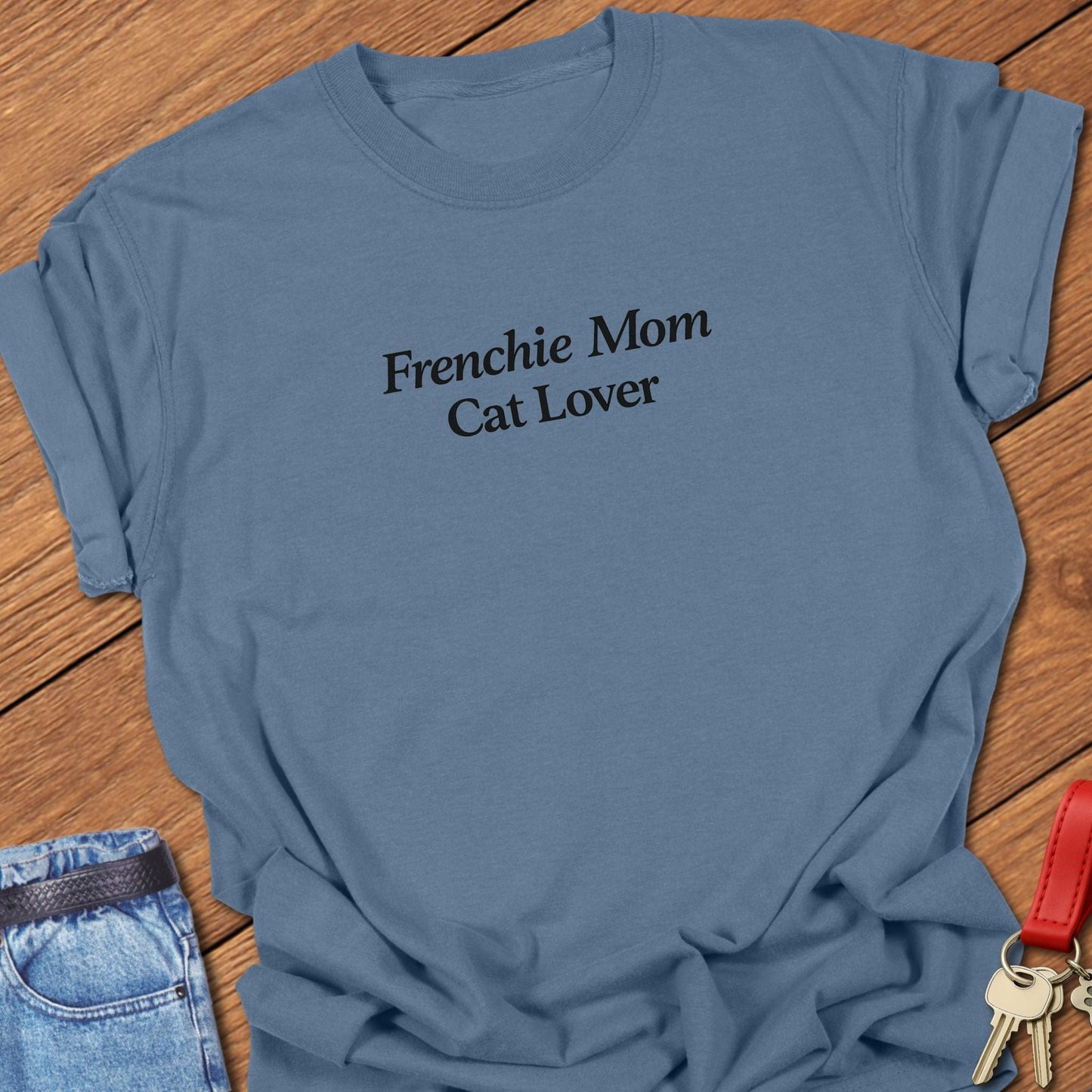 Minimalist serif text design reading “Frenchie Mom Cat Lover” on garment-dyed Comfort Colors t shirt in blue jean.