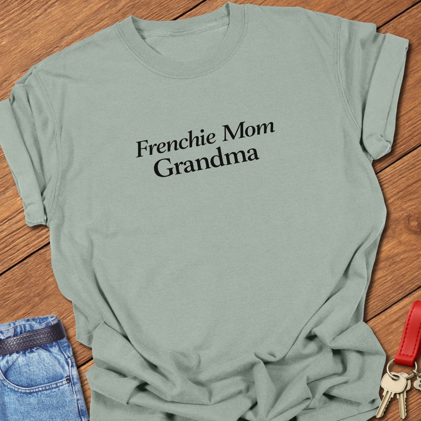 Frenchie Mom Grandma Comfort Colors t-shirt featuring minimalist serif typography in black ink on a bay garment-dyed cotton shirt.
