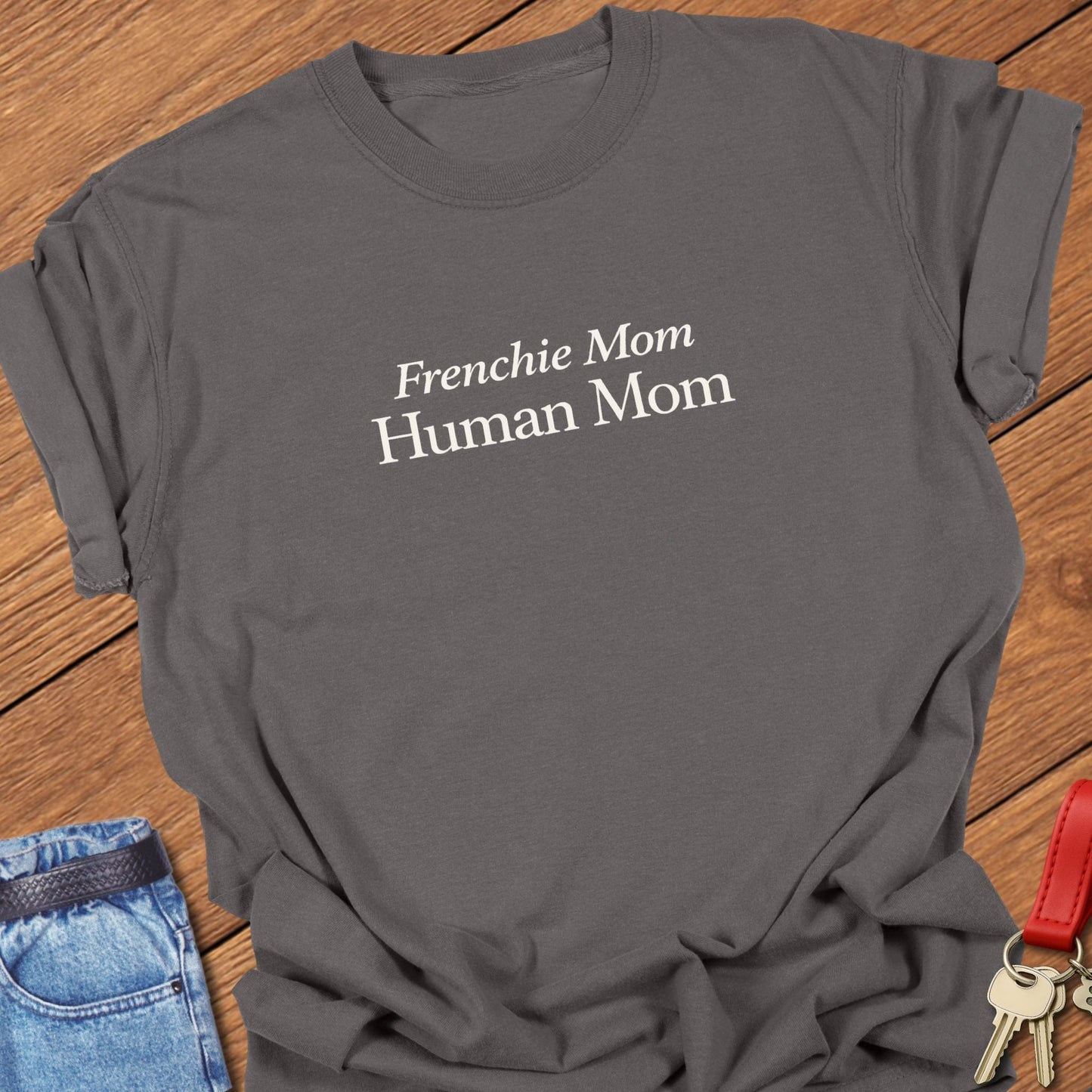 Comfort Colors garment-dyed Frenchie mom t shirt with ivory serif “Frenchie Mom Human Mom” typography on a pepper tee, designed for women balancing motherhood and French bulldog life.
