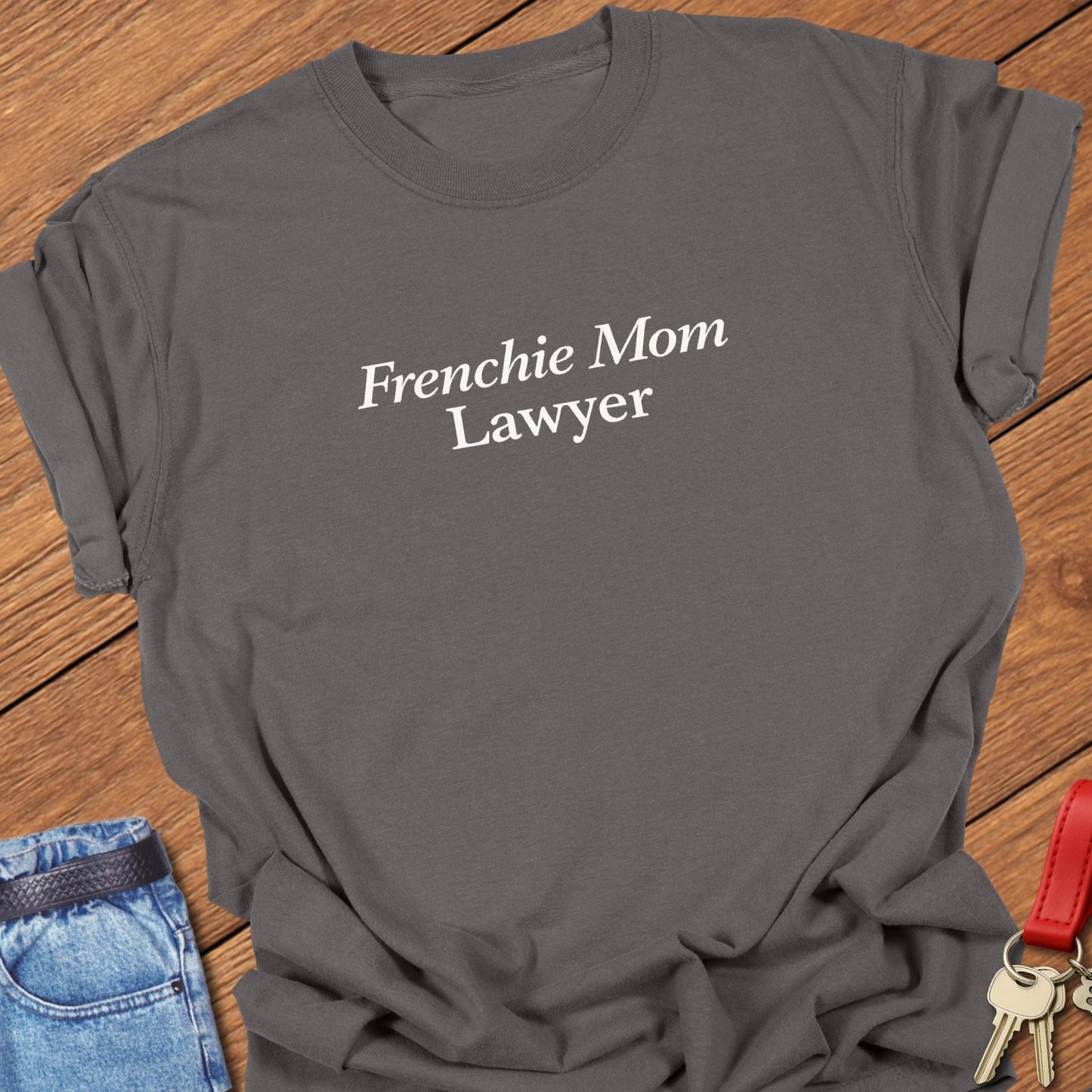 Minimalist serif text design reading “Frenchie Mom Lawyer” on garment-dyed Comfort Colors t shirt in pepper.
