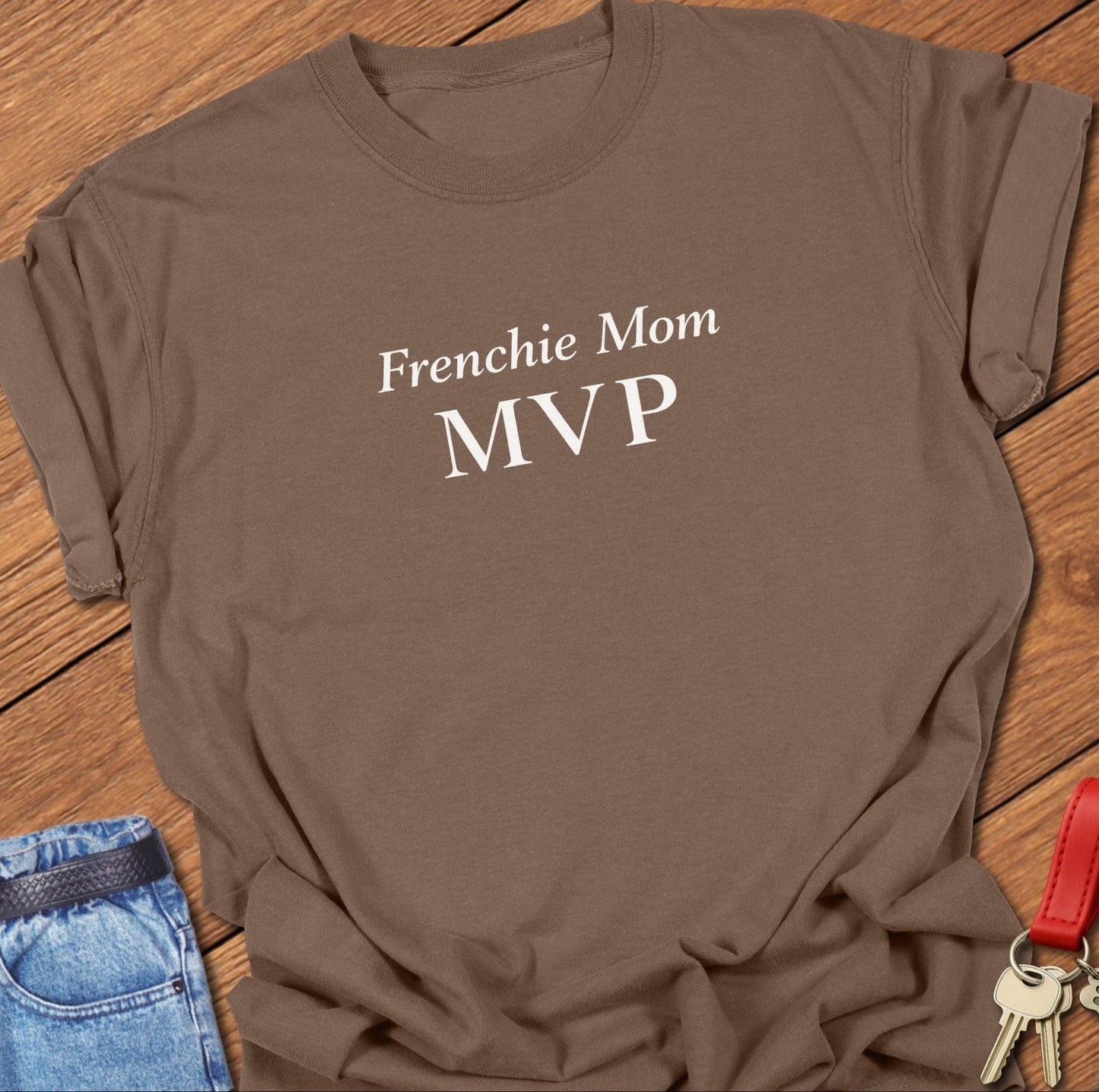 Bold minimalist text design reading “Frenchie Mom MVP” on garment-dyed Comfort Colors t shirt in espresso.