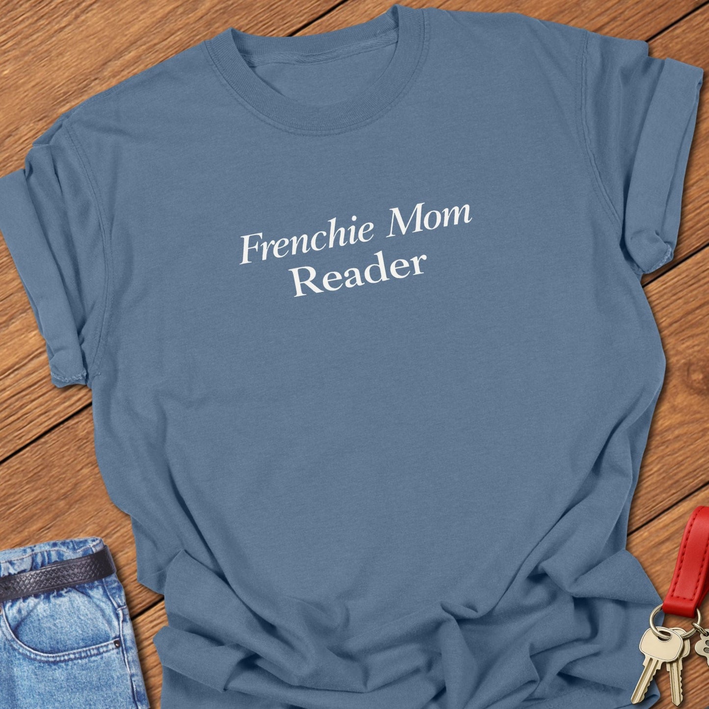 Frenchie Mom Reader text design in classic serif typography on black background minimalist French bulldog mom graphic in blue jean.