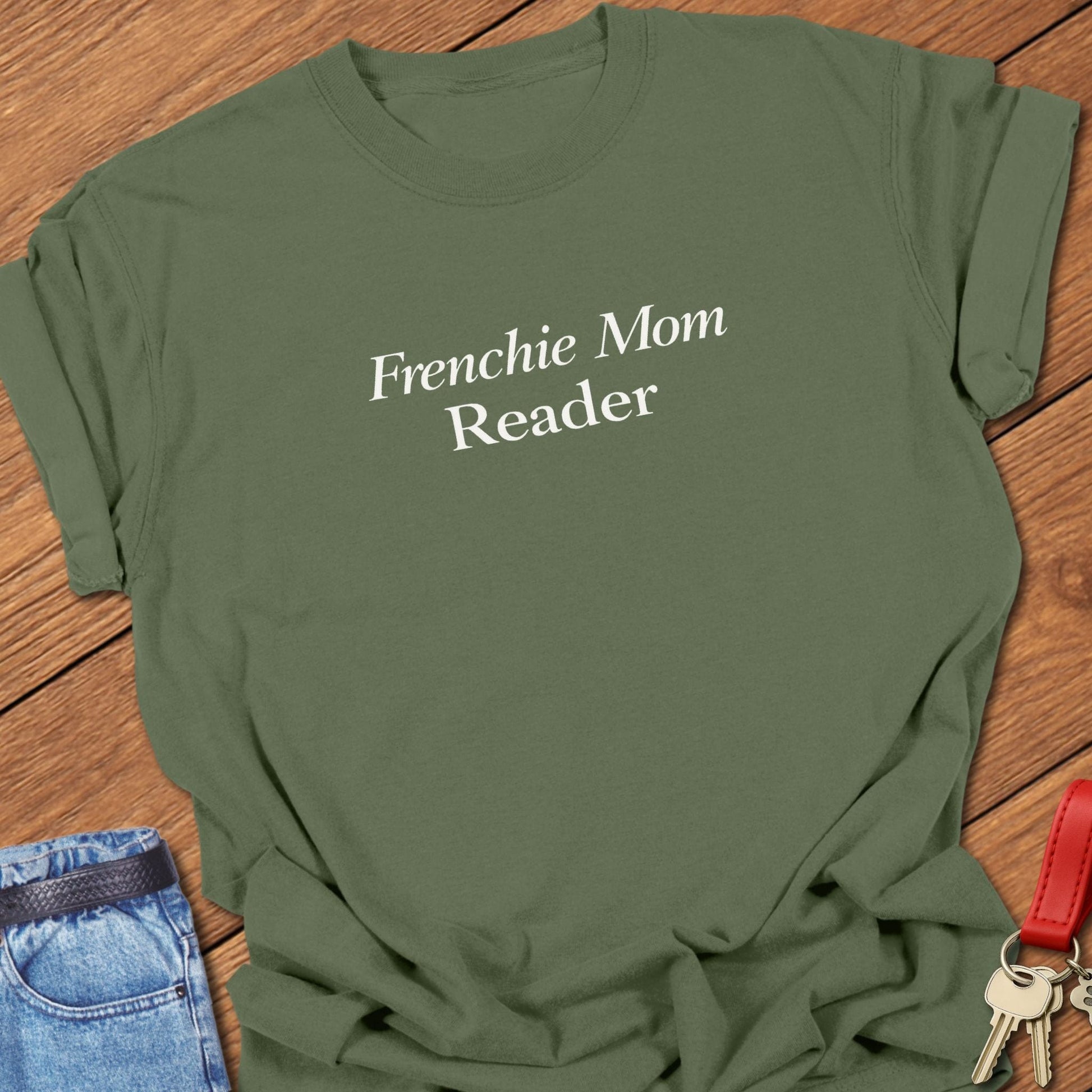 Frenchie Mom Reader text design in classic serif typography on black background minimalist French bulldog mom graphic in moss.
