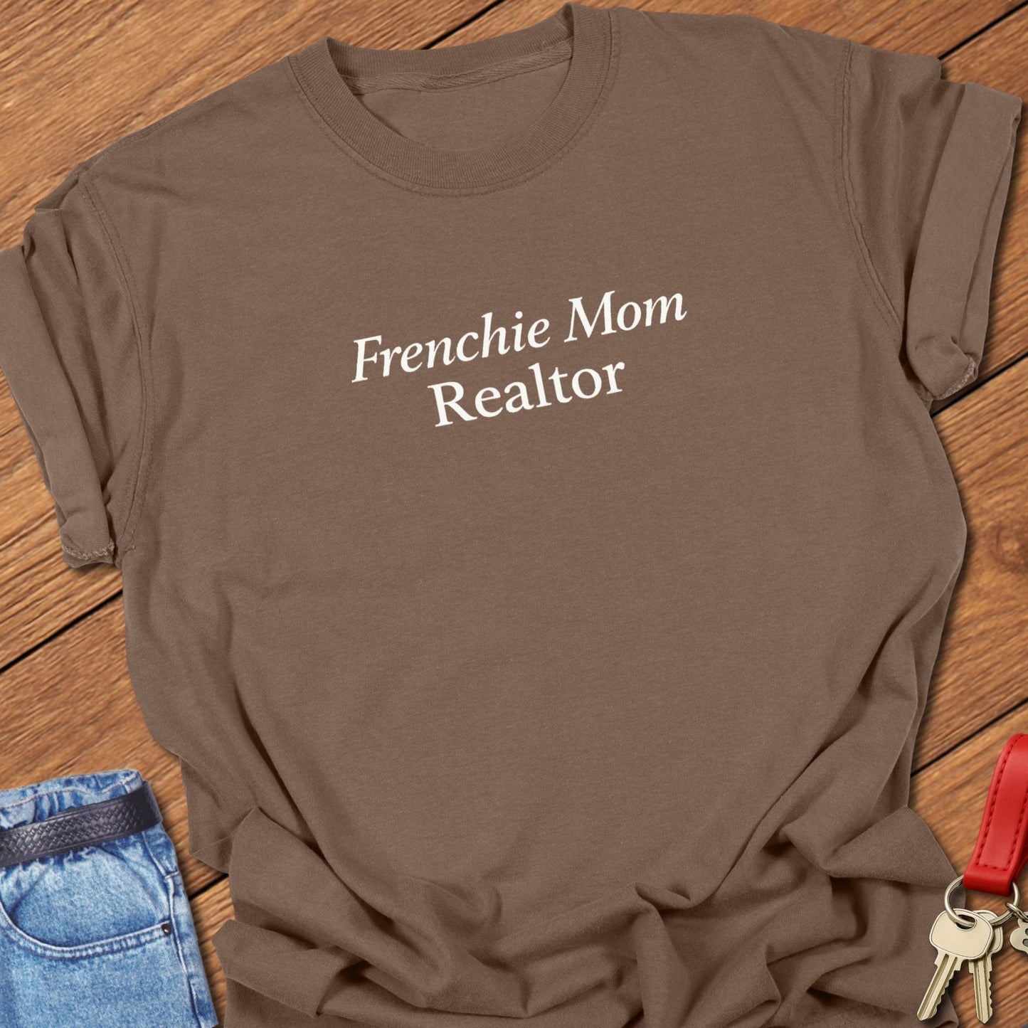 Minimalist serif text design reading “Frenchie Mom Realtor” on garment-dyed Comfort Colors t shirt in espresso.