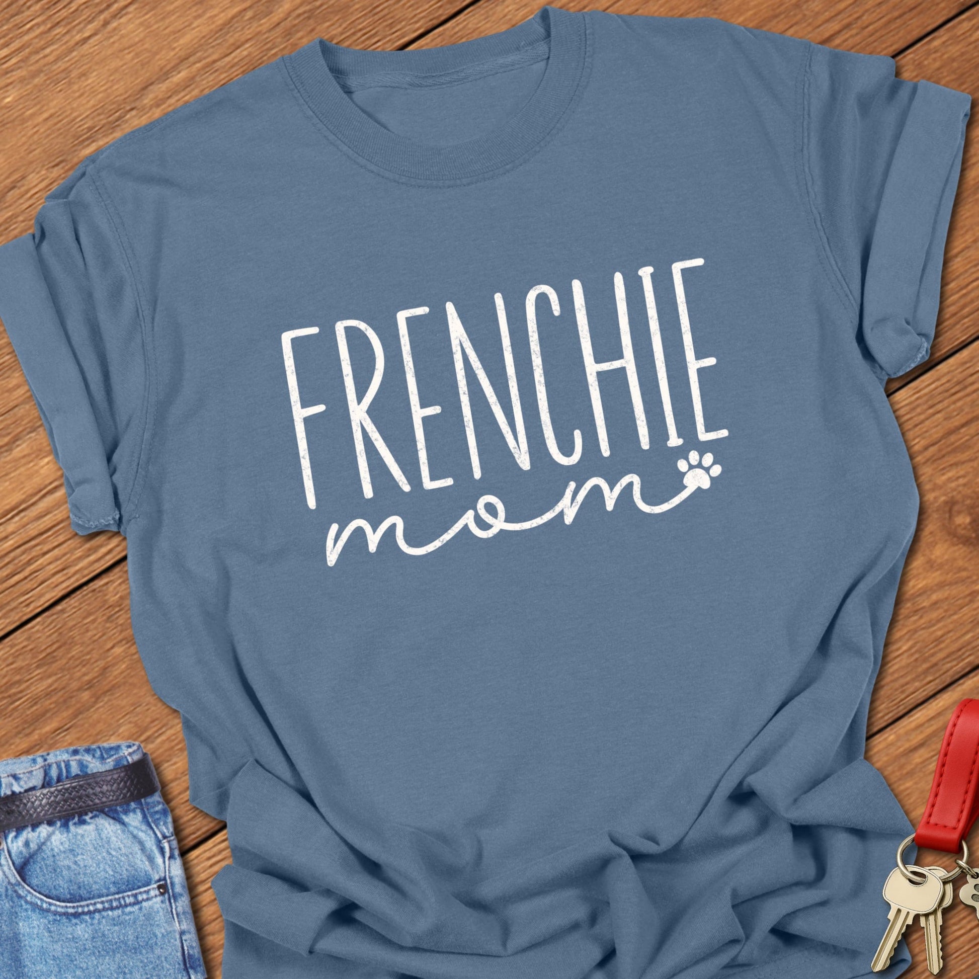 French bulldog mom script typography with paw print accent printed on blue jean Comfort Colors t shirt