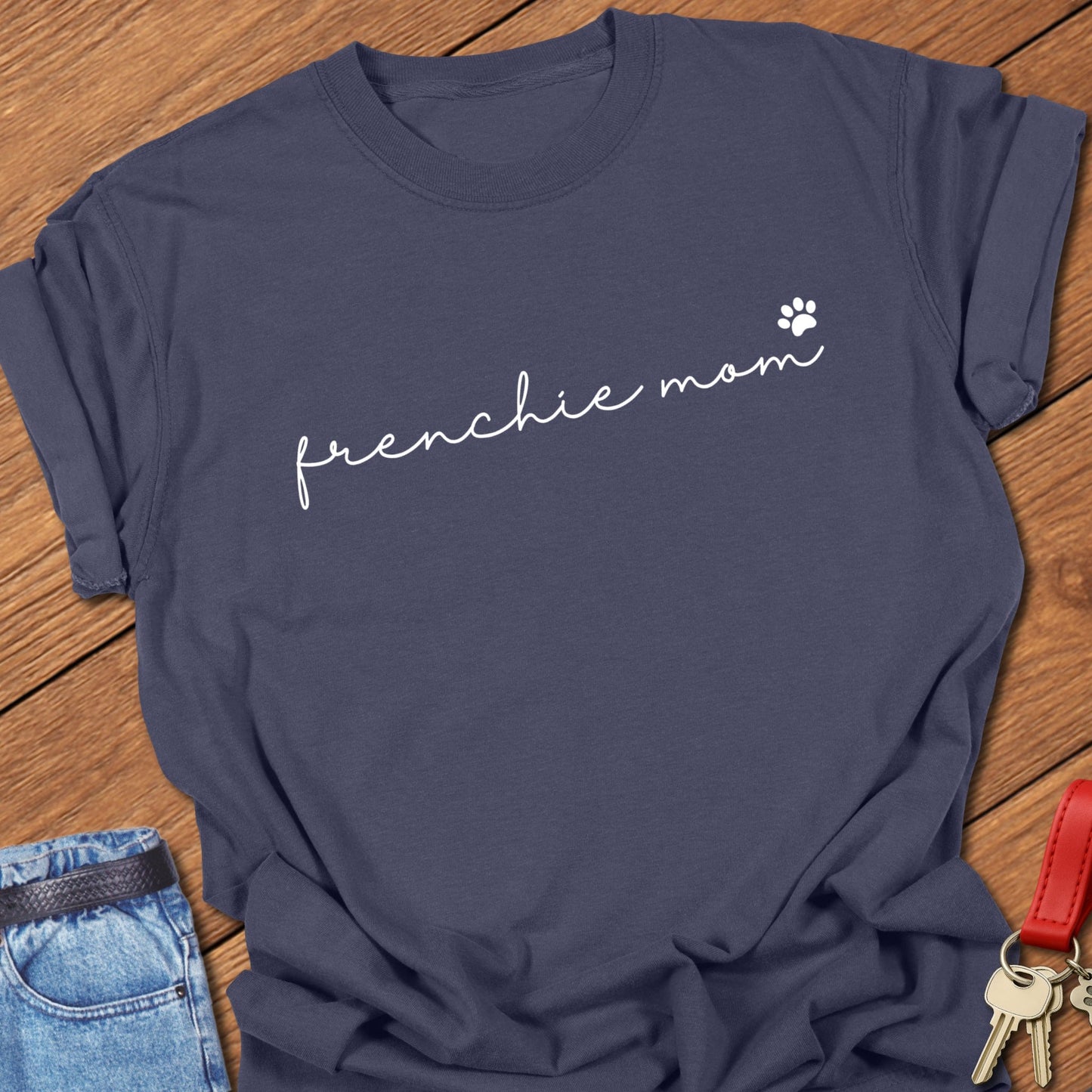 French bulldog minimalist script typography “frenchie mom” with small paw icon printed on navy Comfort Colors t shirt