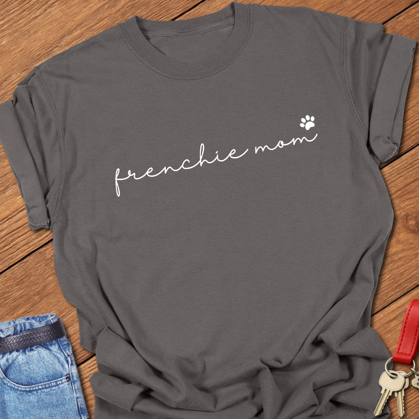 French bulldog minimalist script typography “frenchie mom” with small paw icon printed on pepper Comfort Colors t shirt