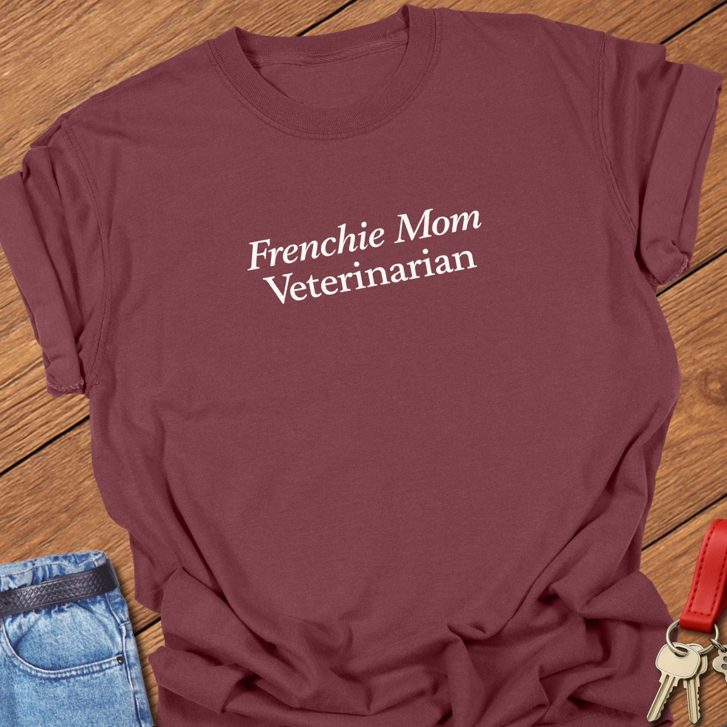 Minimalist serif text design reading “Frenchie Mom Veterinarian” on garment-dyed Comfort Colors t shirt in brick.