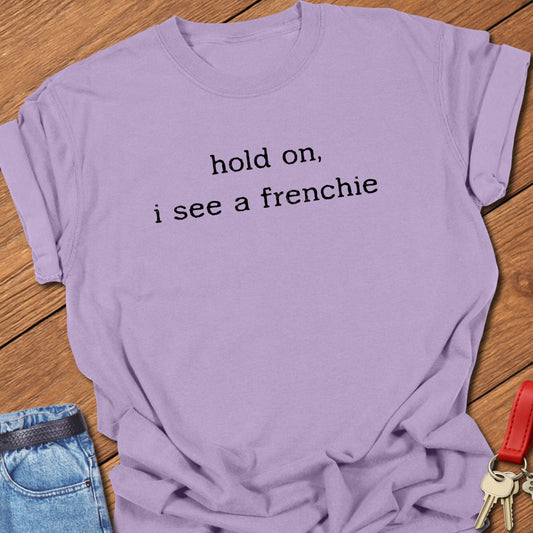 French bulldog minimalist text design reading “hold on, i see a frenchie” printed on orchid Comfort Colors t shirt