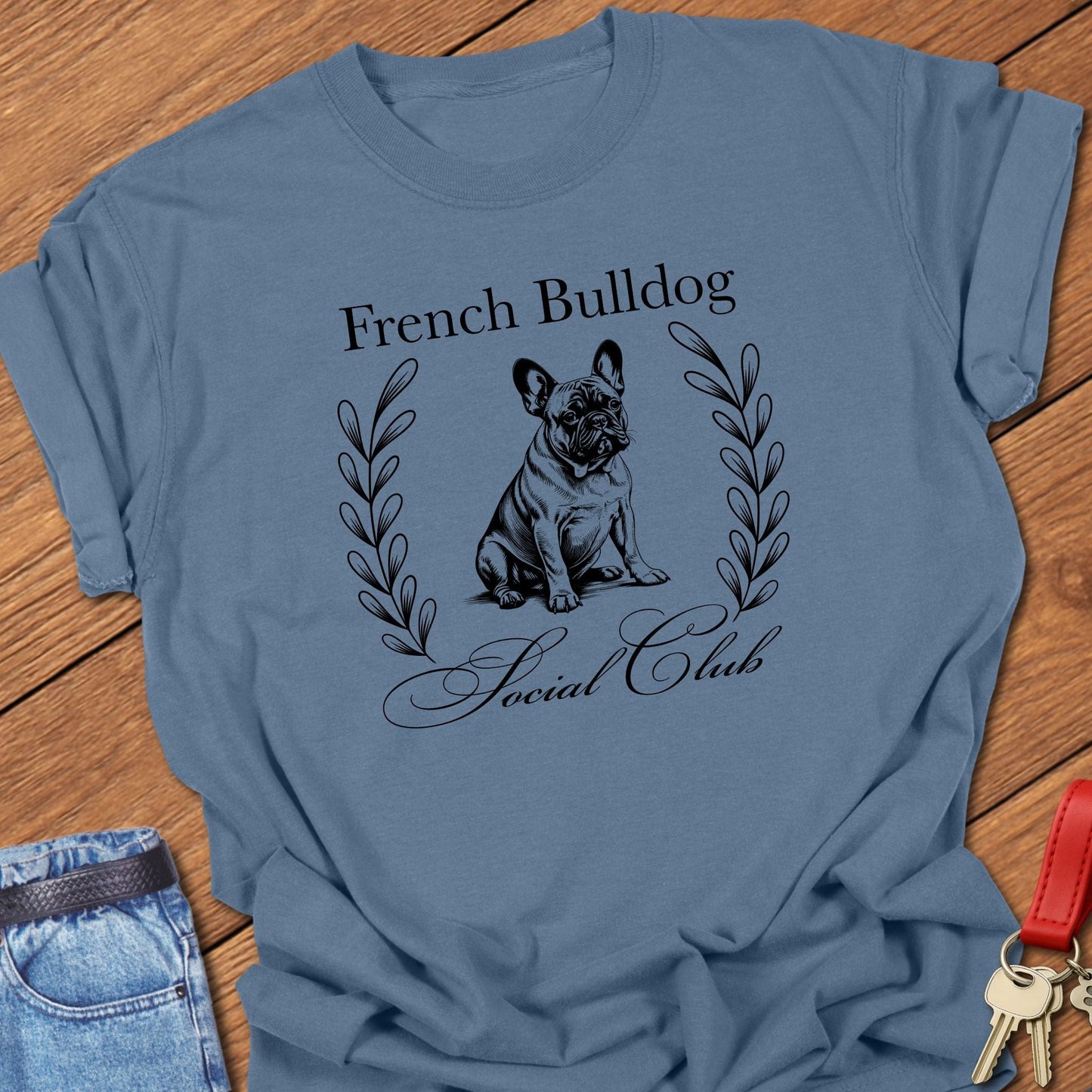 French bulldog vintage line art design with laurel wreath printed on blue jean Comfort Colors t shirt.