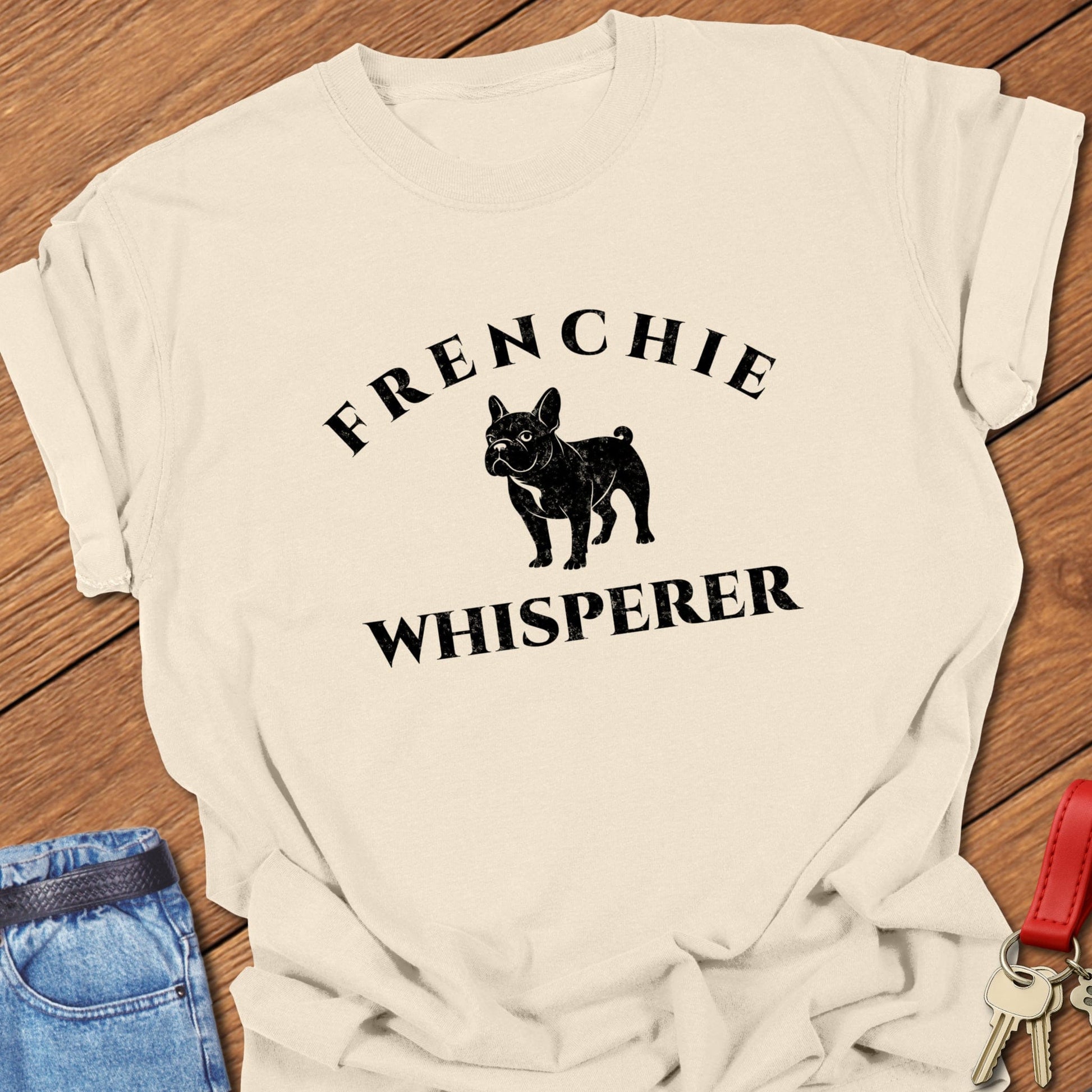 French bulldog “Frenchie Whisperer” text with vintage French bulldog silhouette graphic printed on ivory Comfort Colors t shirt