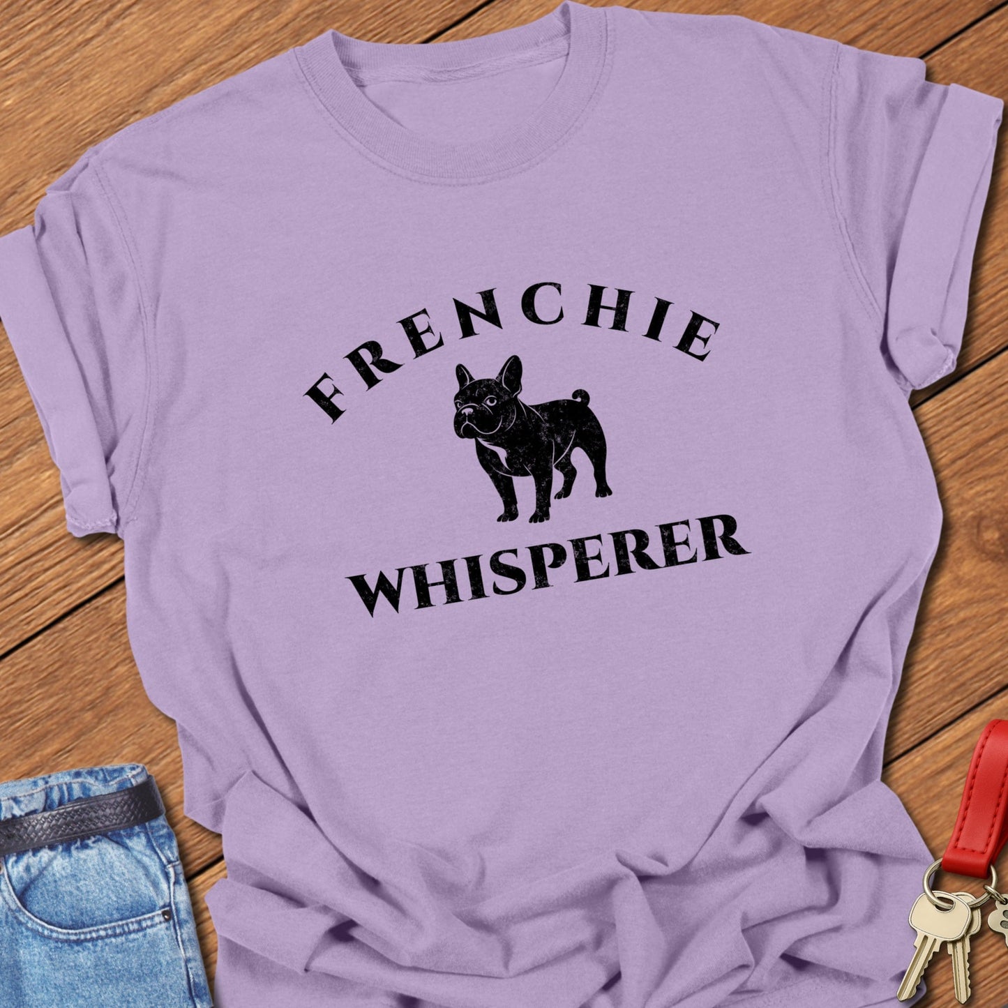 French bulldog “Frenchie Whisperer” text with vintage French bulldog silhouette graphic printed on orchid Comfort Colors t shirt