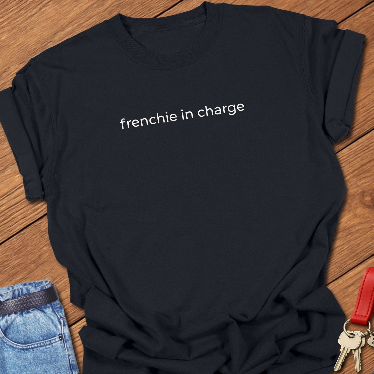 French bulldog frenchie in charge text graphic printed on black Comfort Colors t shirt.