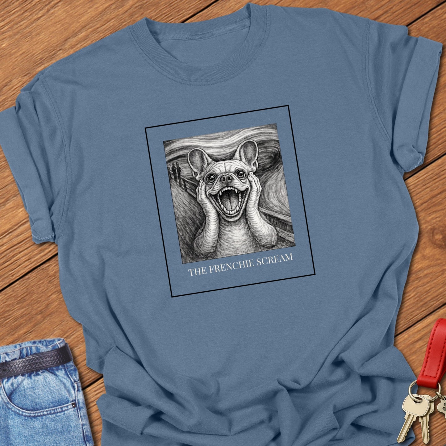 French Bulldog art parody illustration inspired by Edvard Munch’s famous painting The Scream, featuring a dramatic Frenchie expression on a museum-style graphic t-shirt in Blue Jean.