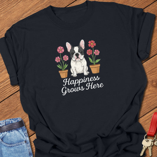 French bulldog illustrated puppy with flowers and “Happiness Grows Here” text printed on black Comfort Colors t shirt