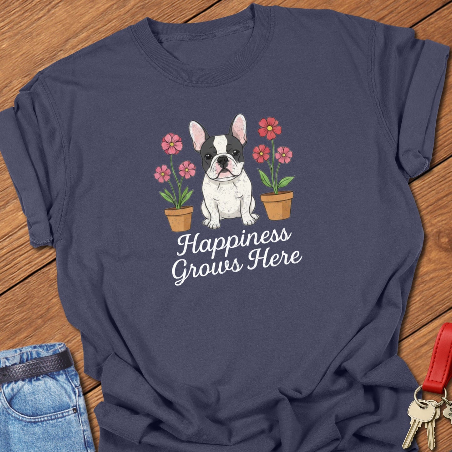 French bulldog illustrated puppy with flowers and “Happiness Grows Here” text printed on navy Comfort Colors t shirt