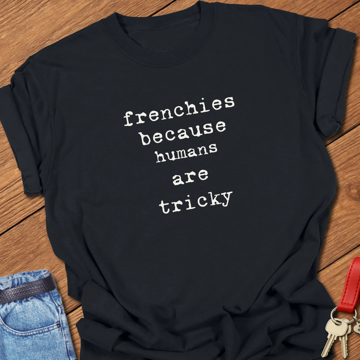 Black Comfort Colors French Bulldog t-shirt featuring the phrase "Humans Are Tricky" in vintage ivory typewriter typography.